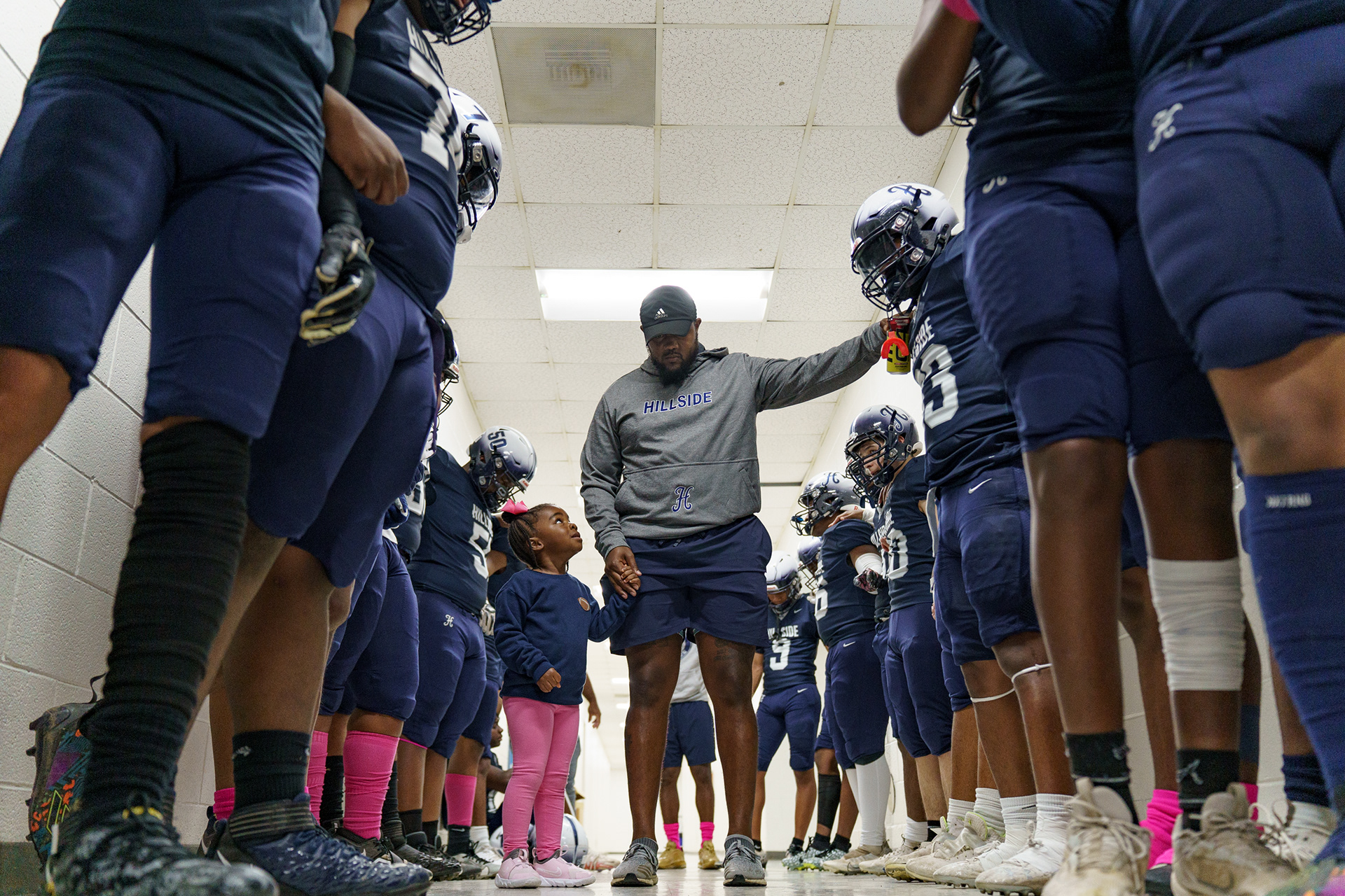Hillside High School football head coach Torrey Nowell joined the team in July of 2023, only a couple months before the beginning of a season. With almost no returning players, a new coach was tasked with leading a new team to victory throughout the 2023 season. As he prays with his team before a game, he tries to bridge the gap between them.