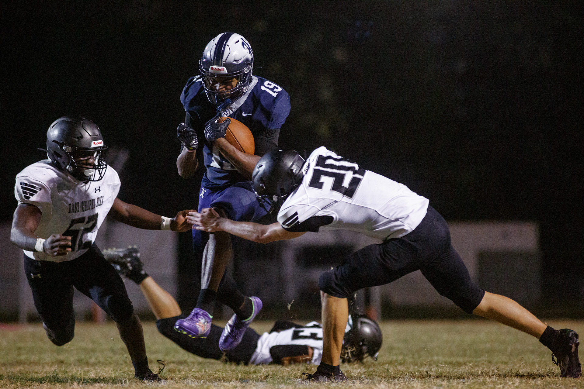 Hillside senior RB Desmond Smith (19) breaks through East Chapel Hill defenders. Despite their lack of experience, Hillside managed to win the first game of the season.