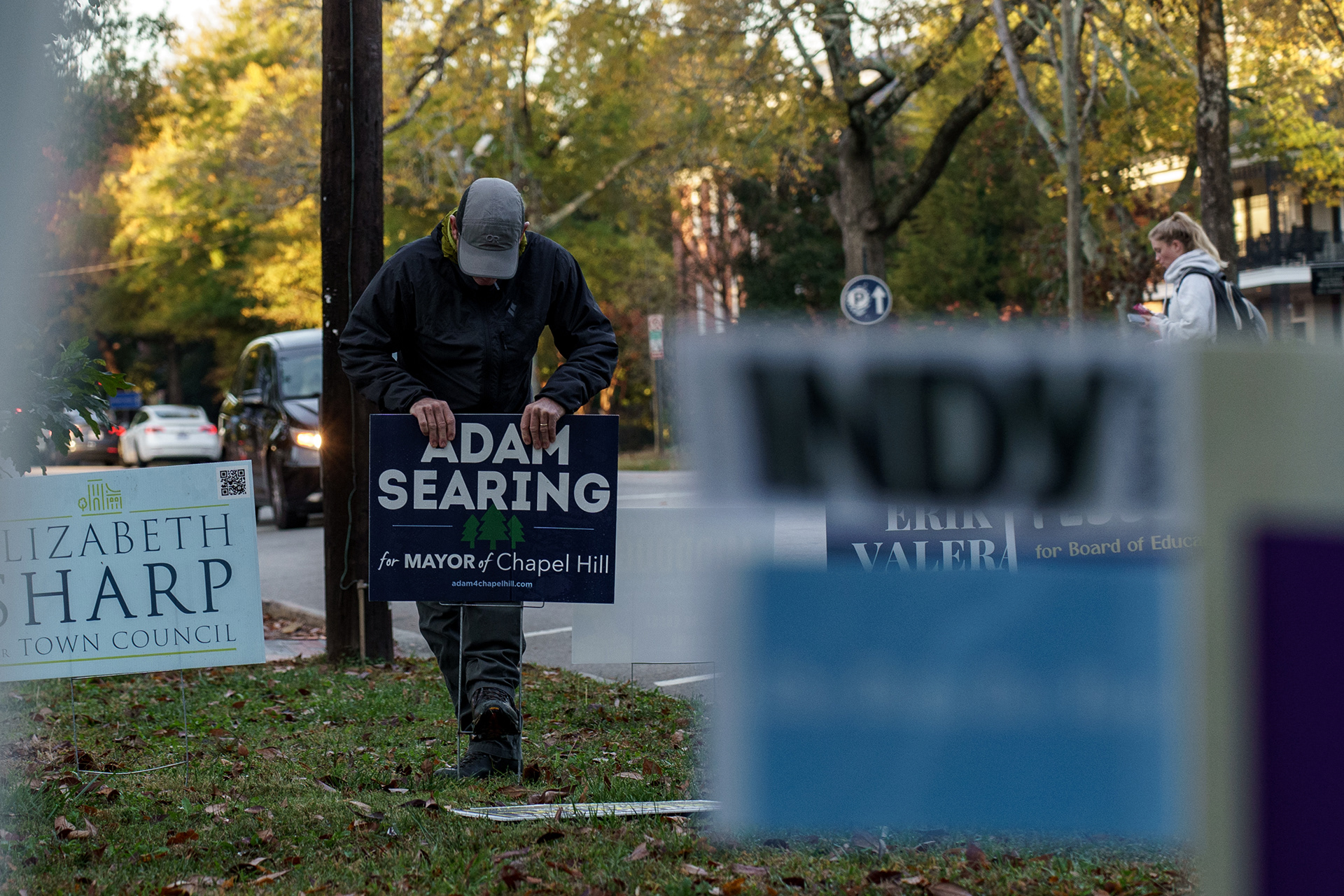 Right after sunrise during the early voting period, Adam puts up campaign signs outside a polling location. “Yard signs don’t vote,” he says, but he still puts them up everywhere he goes. In a local election where previous races have been decided by single digits, it’s vital to be known.