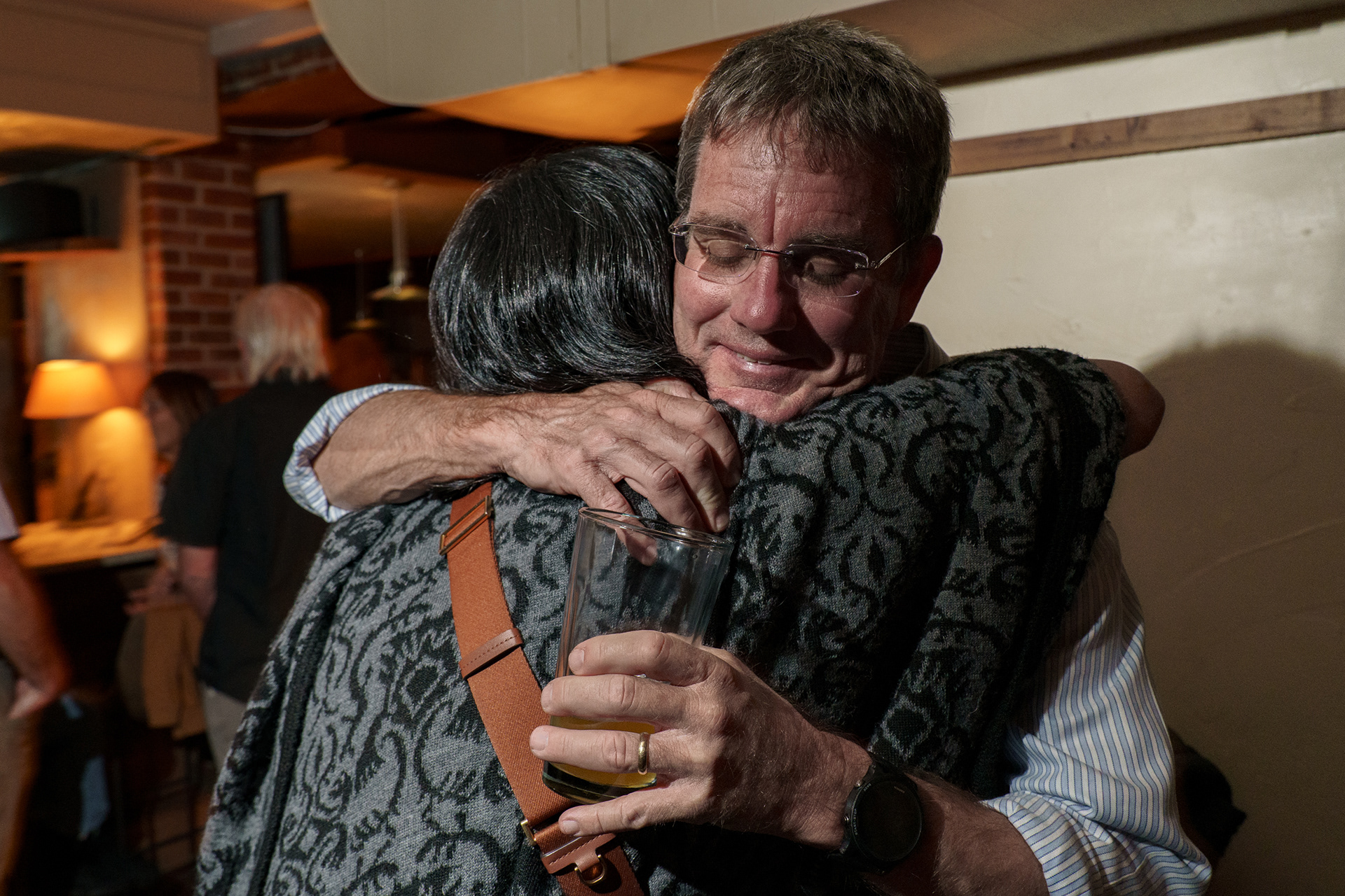 As part of his goal of making tangible changes, Adam is running at the head of a slate of five Town Council candidates. On election night he hugs Renuka Soll, one of the slate candidates. If the full slate were to be elected, they would have a majority in the council and be able to overturn prior zoning decisions.