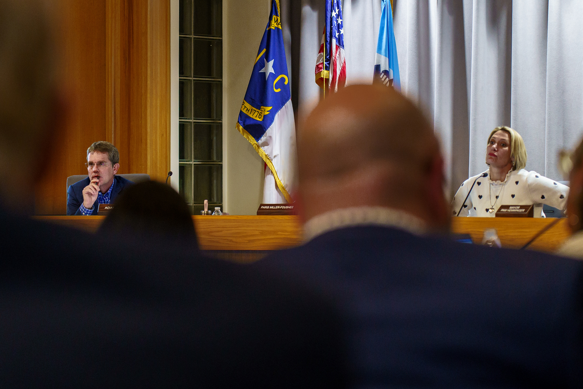 Adam still holds his seat on the Chapel Hill Town Council, and will maintain it if he loses the election. Sitting near him is Jess Anderson, his opponent and the one who received the previous mayor’s endorsement. “I really don’t do this because I want to be in a different office,” says Adam. “The only reason to do this is to try and volunteer in your community and make changes you want to see.”