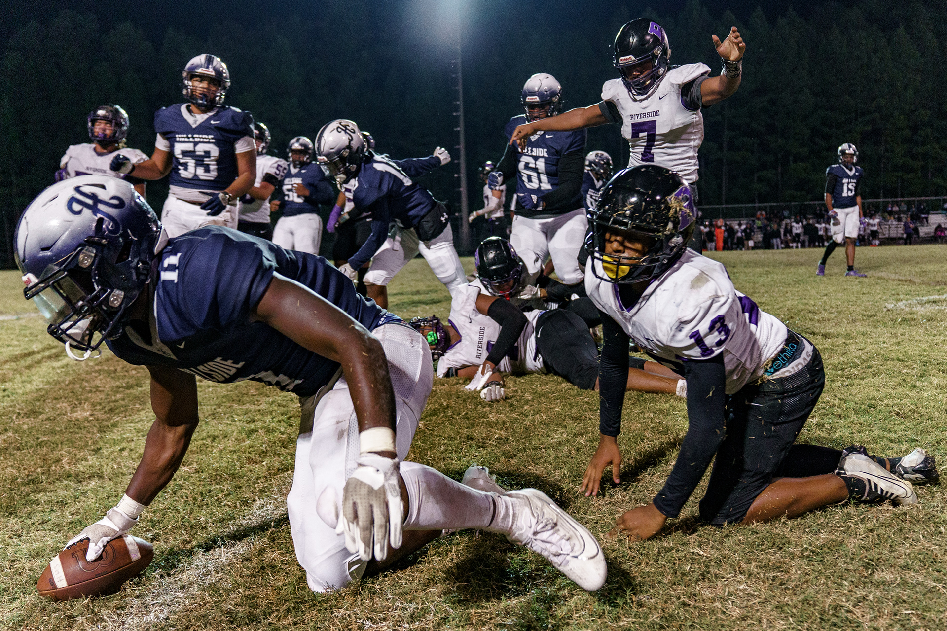 Hillside junior RB Ameil Braswell (11) is brought to the ground by Riverside defenders. "He turned into a monster as the season went on," said Coach Nowell as he praised Braswell.