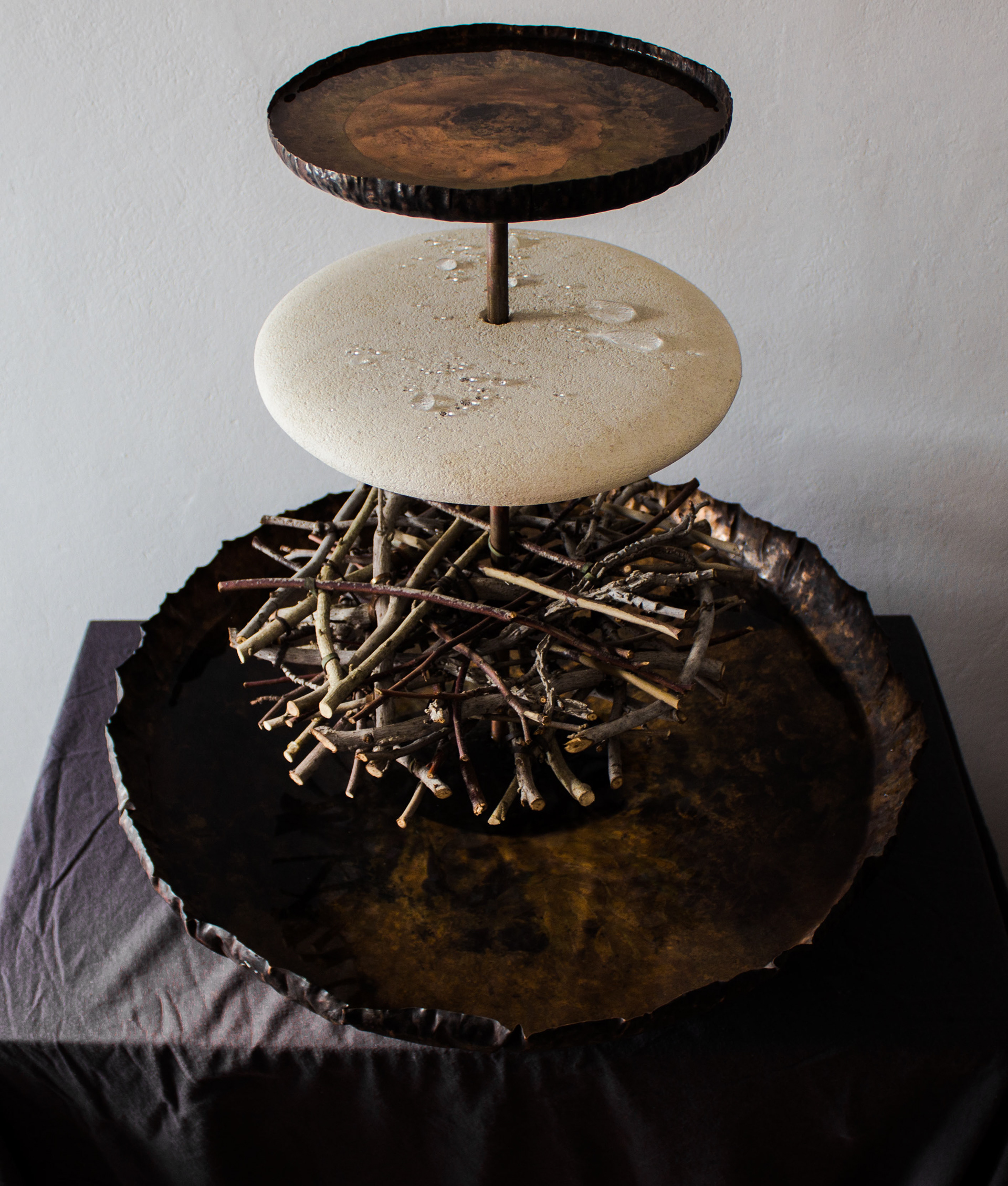 Rain machine needs the audience to keep filling the top vessel with water from the bottom one to keep the cycle going