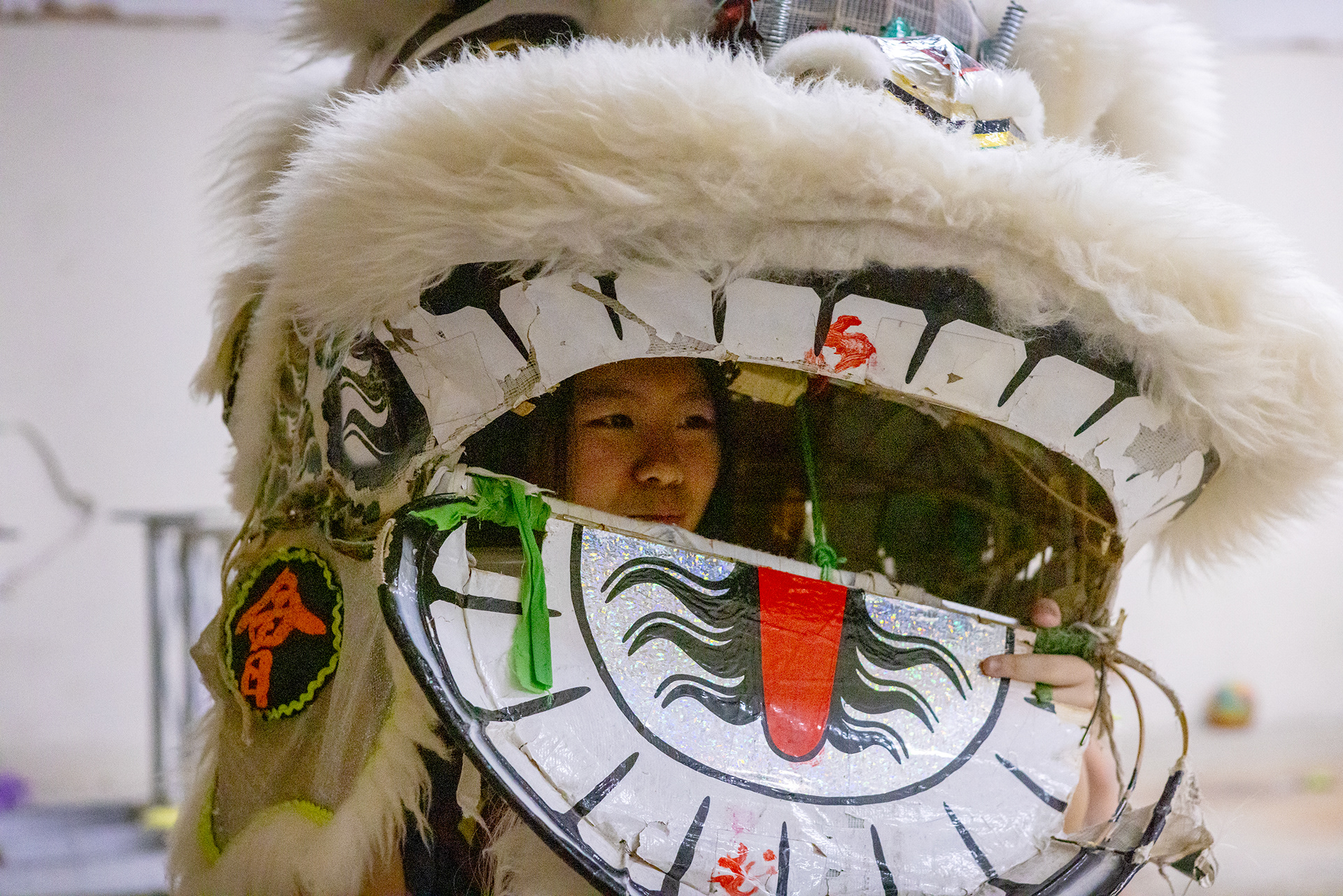 JL Lion Dance member Emma Tran tries on a lion head during practice in Garland, Texas on Oct. 18, 2025.