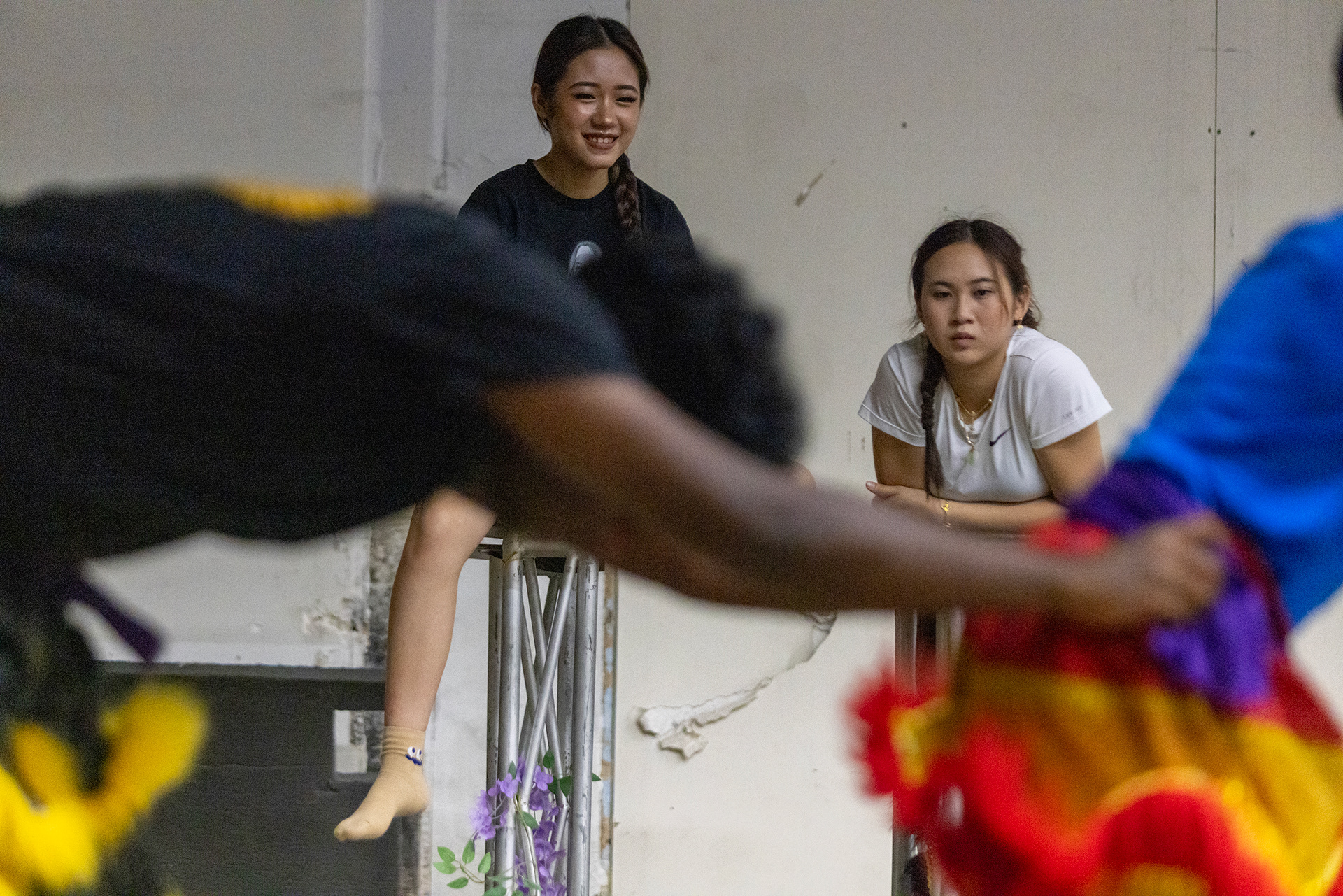 JL Lion Dance troupe member Alexa Ngo (left) and co-captain Emily Chea critique new recruits' lion head and tail movements in Garland, Texas on Oct. 18, 2025.