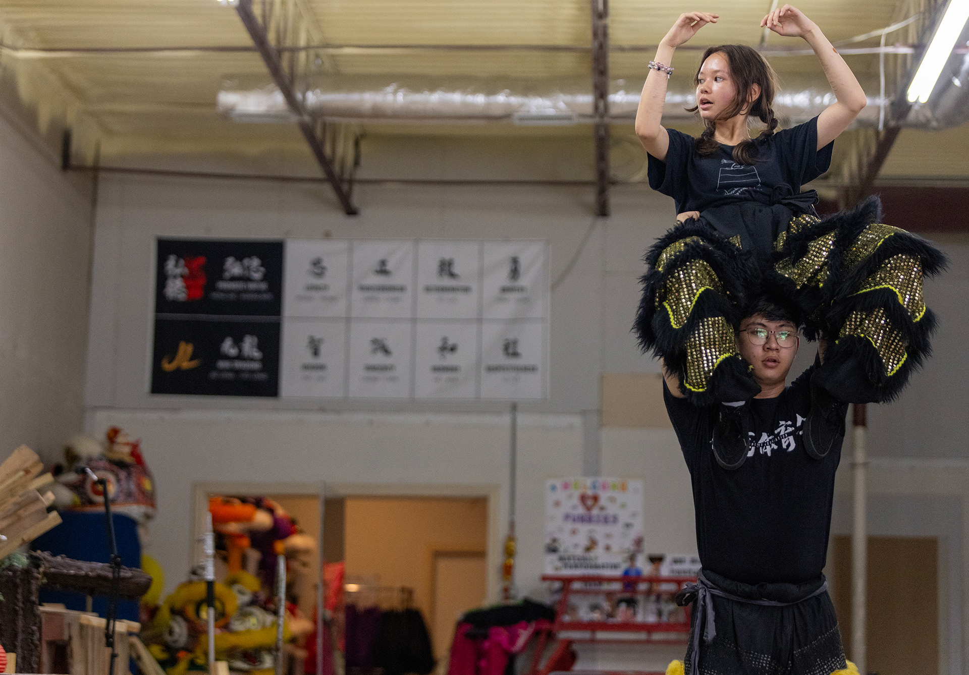 JL Lion Dance troupe member Elena Davis (top) practices lifts with her teammate Nicholas Pham in Garland, Texas on Oct. 18, 2025.