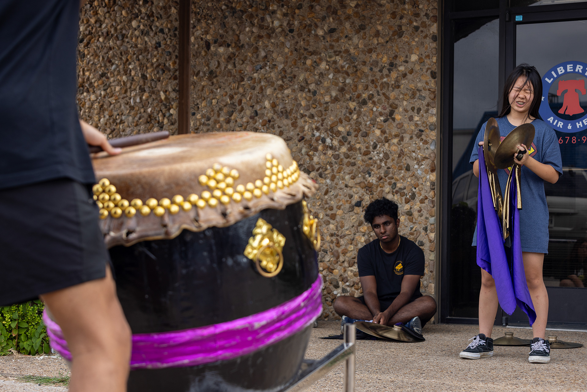 JL member Emma Tran adjusts her timing during her cymbal performance test outside of the JL training facility in Garland, Texas on Oct. 18, 2025.