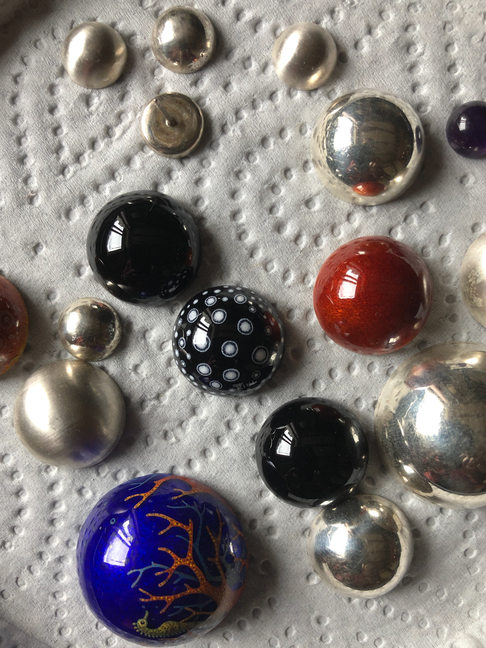 Enamelled cabochons.
