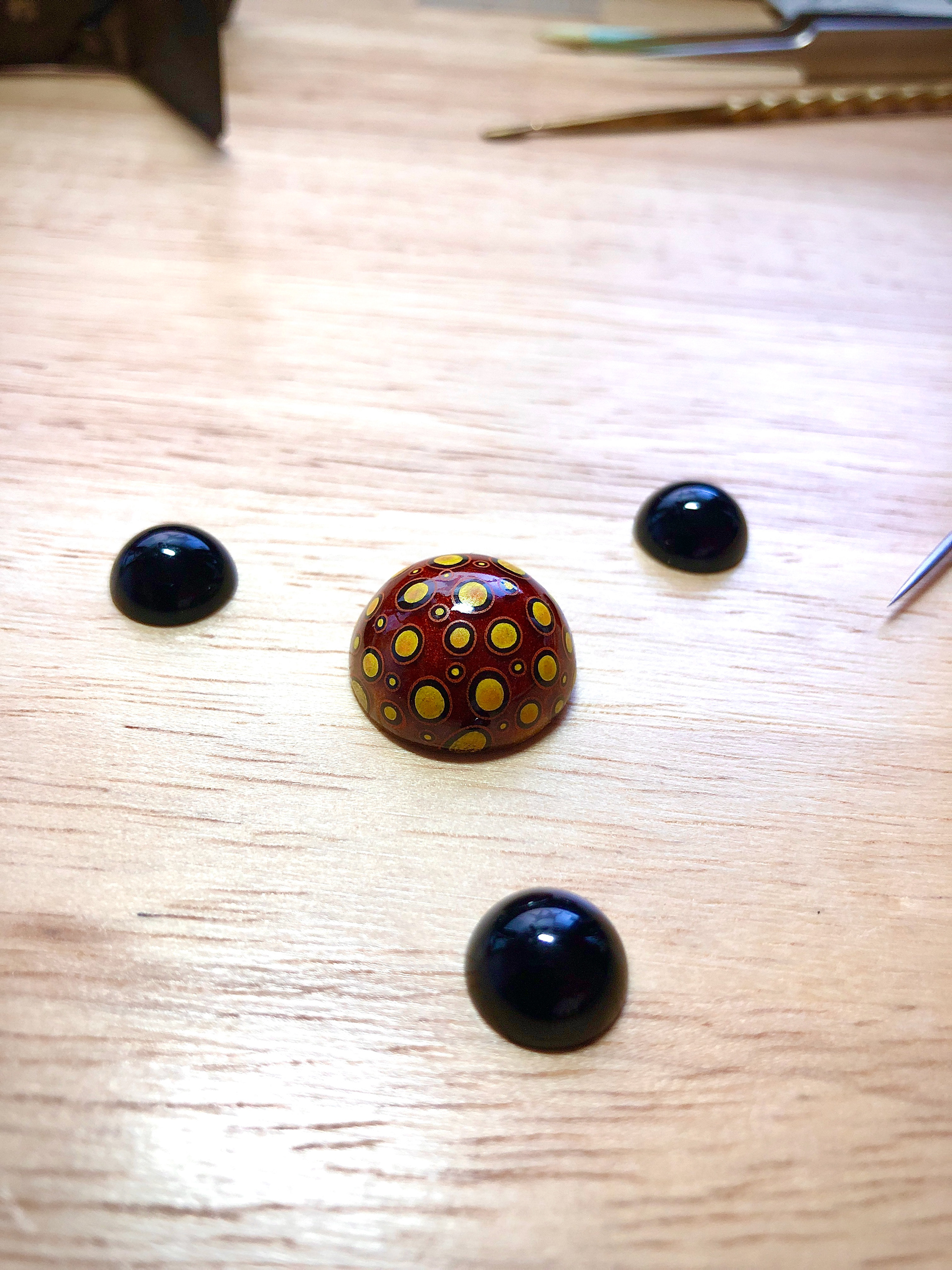 Silver hemisphere with the transparent hot enamel coating. Miniature painting with the overglaze colours. Onyx cabochons. .