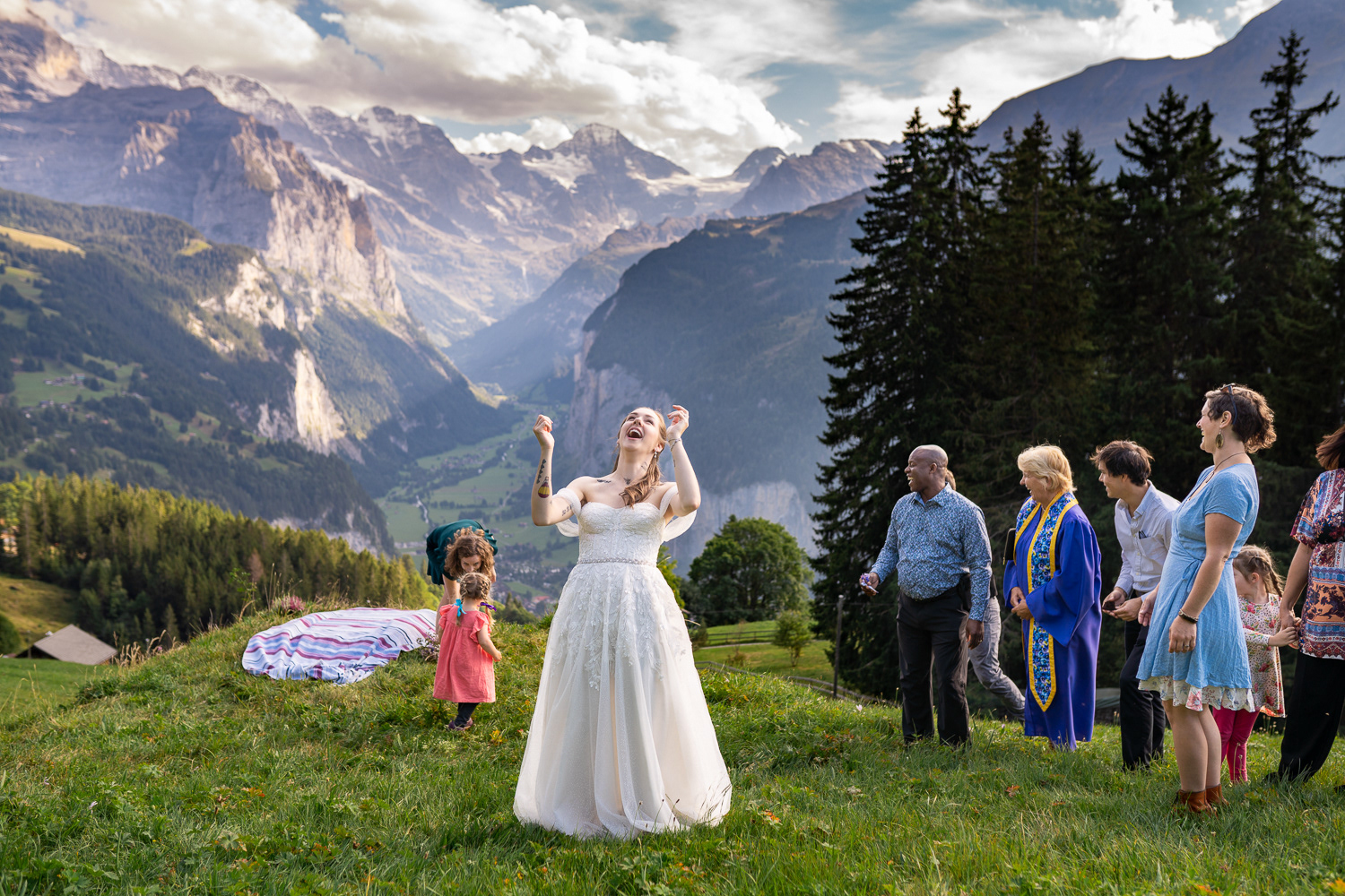Buquet toss above Lauterbrunnen Valley in Swiss Alps during Elopement in Switzerland