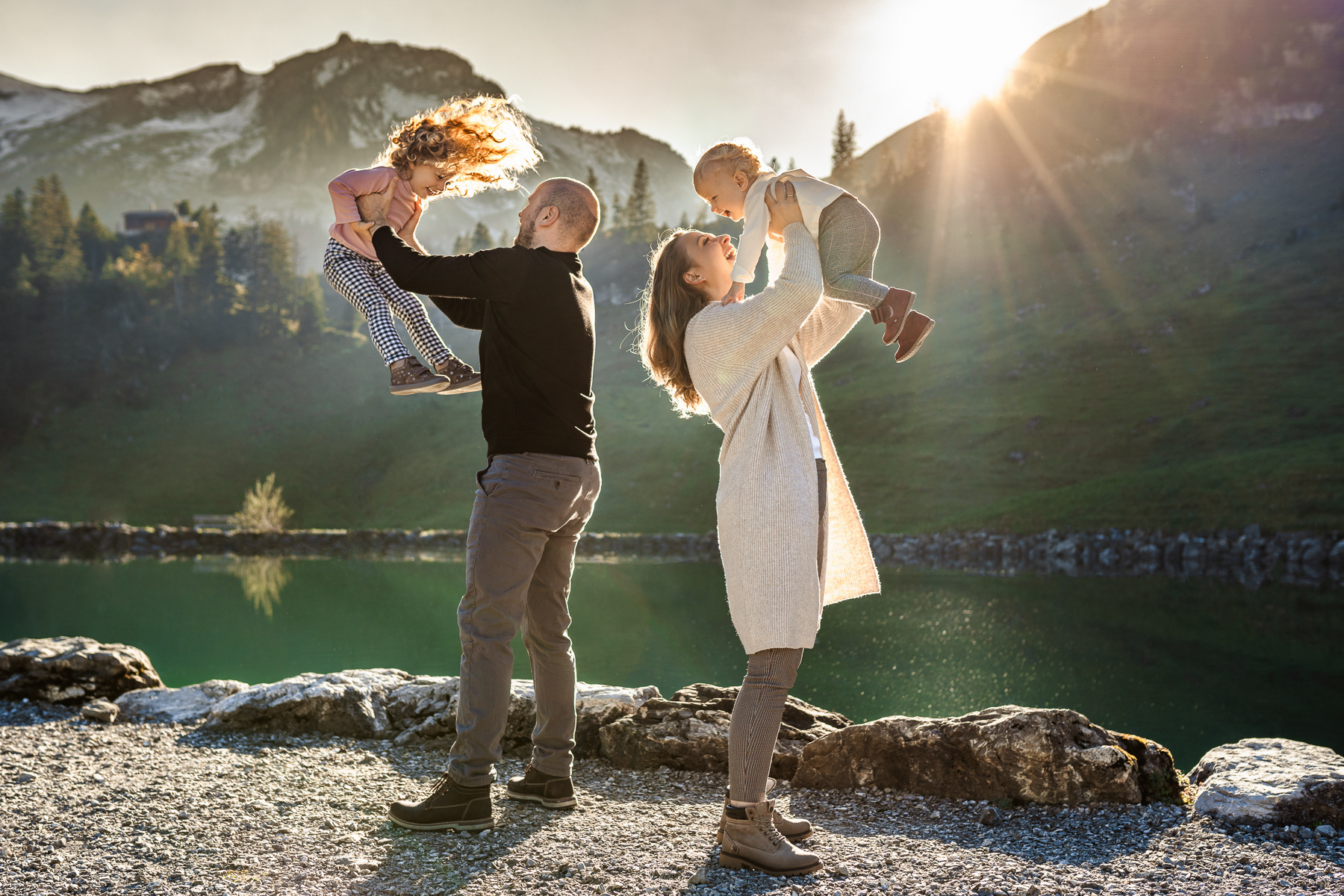 mother father and kids on holidays in swiss alps in central switzerland