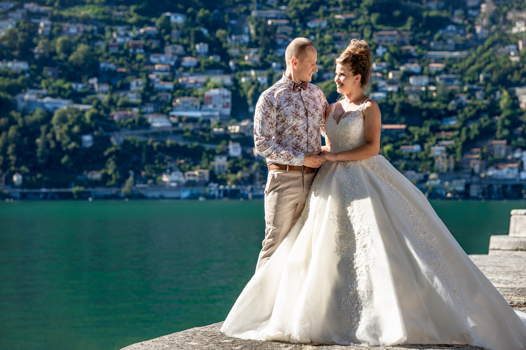 newlyweds looking at each other on the shore of the Lago maggiore in tessin - south part of switzerland