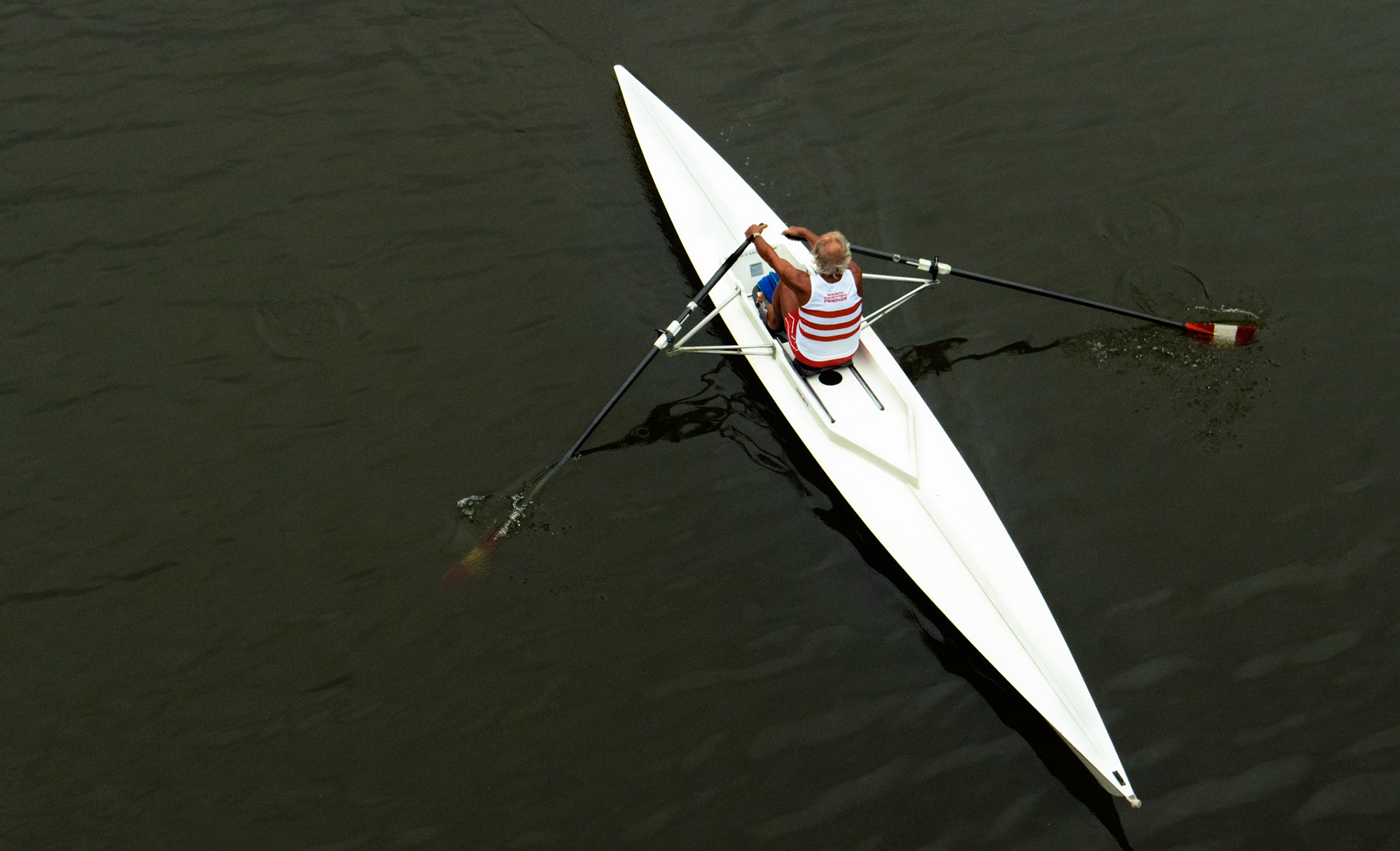 Rowing shell crossing under Ponte Vecchio