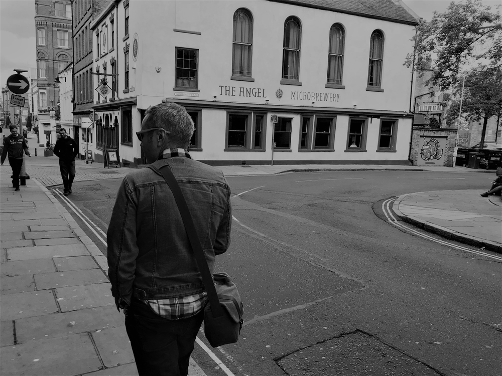 The photographer walking along the streets of Nottingham, United Kingdom