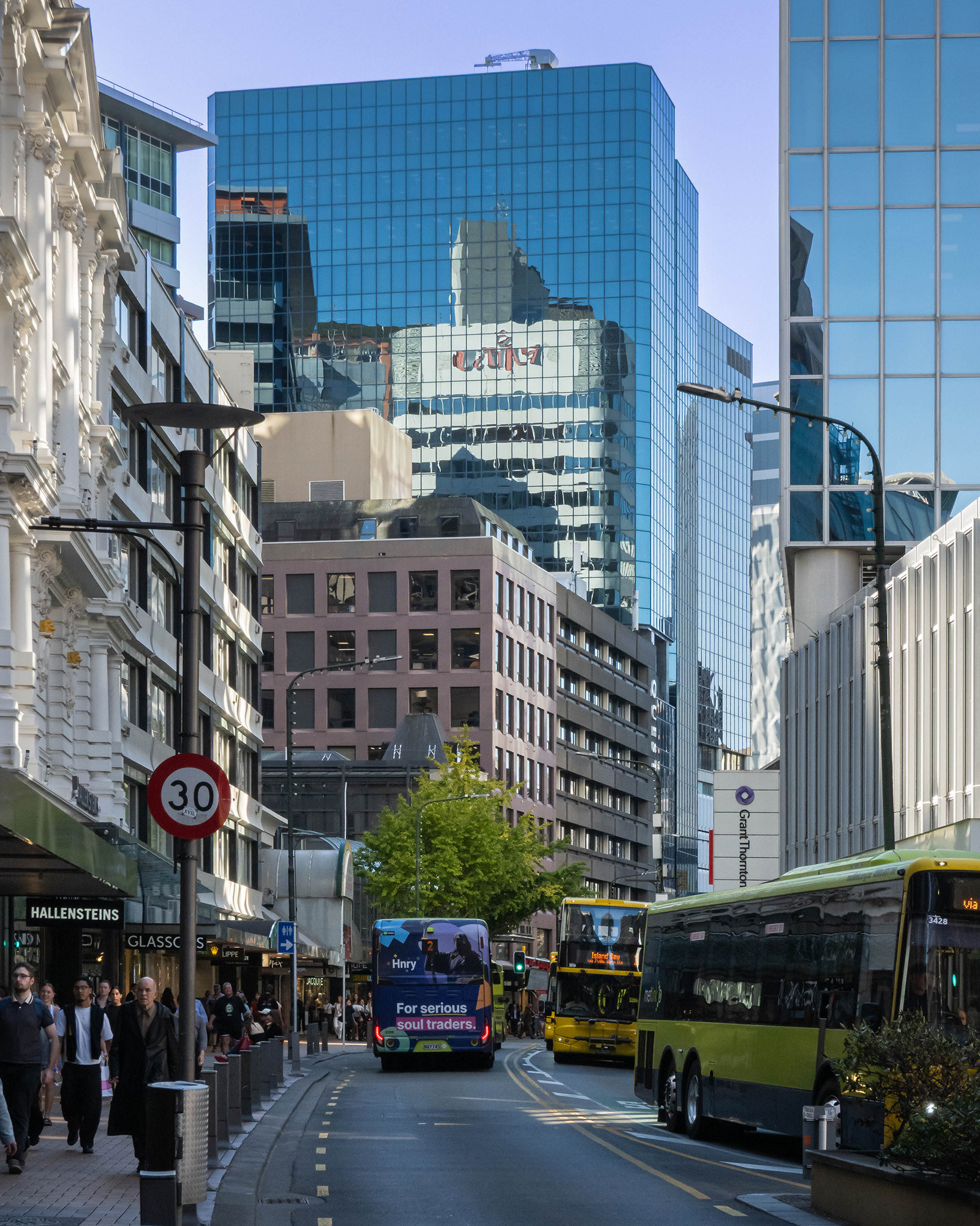 View taken down Lambton Quay showing city reflections in the taller buildings