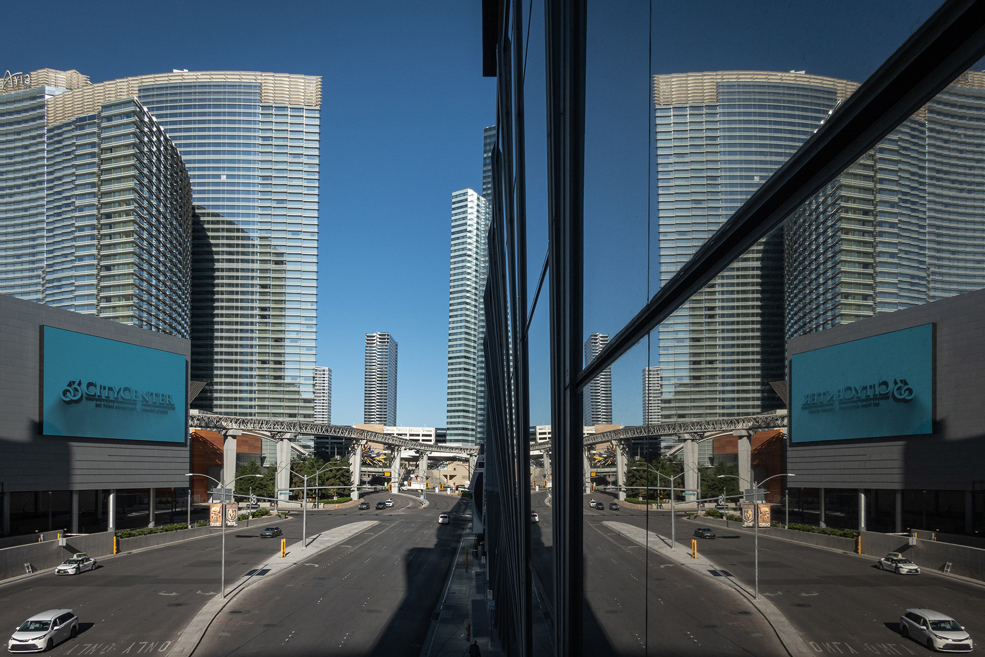 The Aria hotel building reflected in adjacent glass windows 