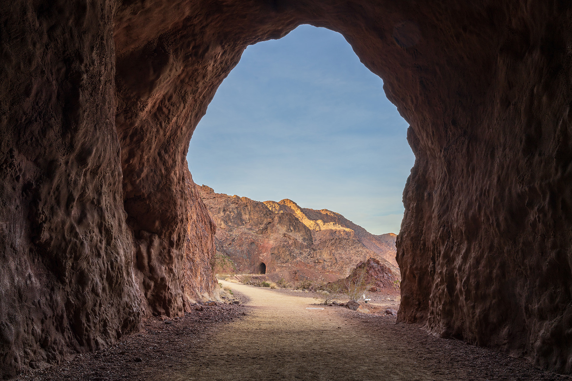 Landscape vista showing the entrance to a tunnel in the historic railroad trail