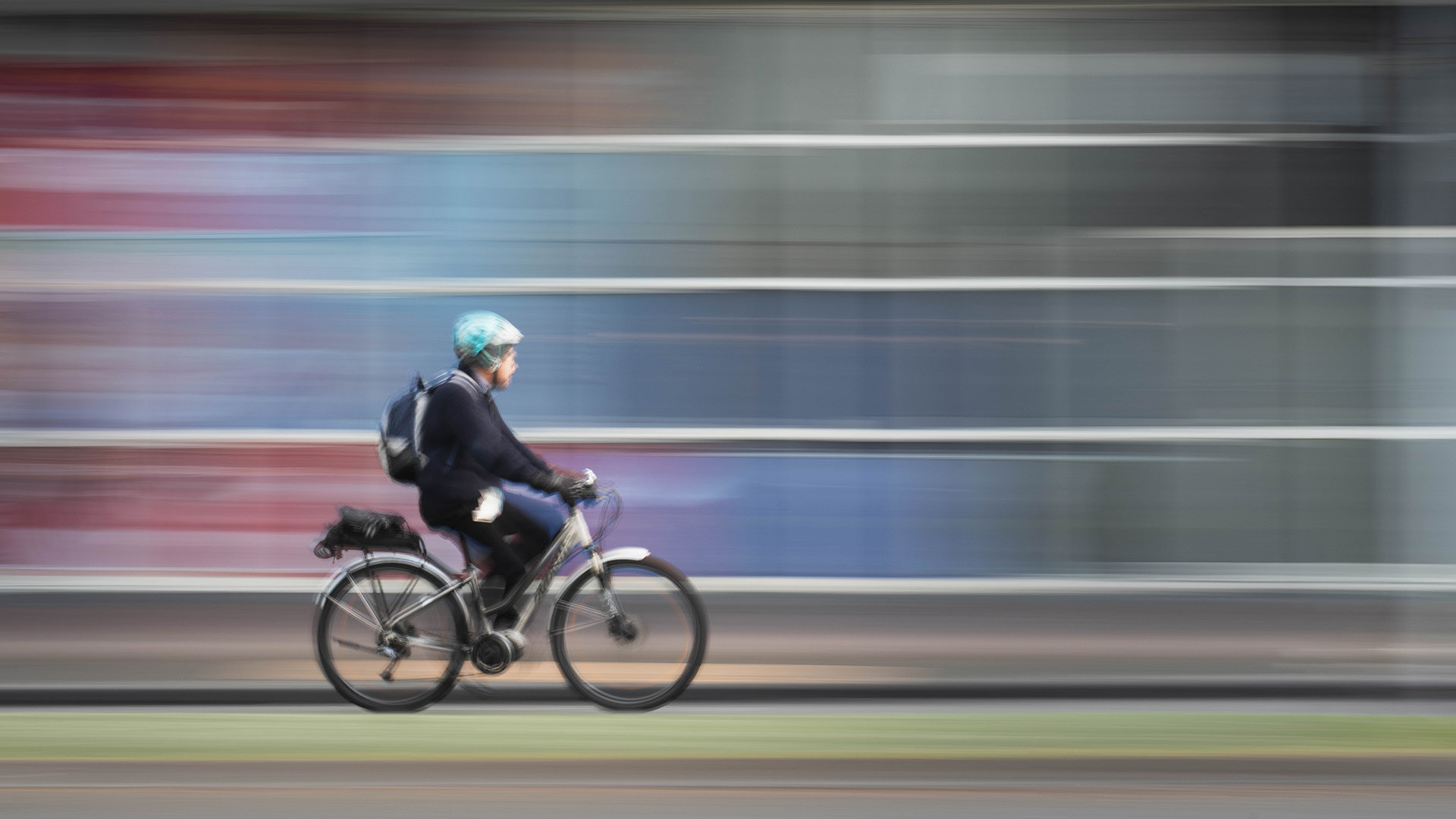 Long exposure intentional camera movement shot of a cyclist in Victoria Street, Hamilton 