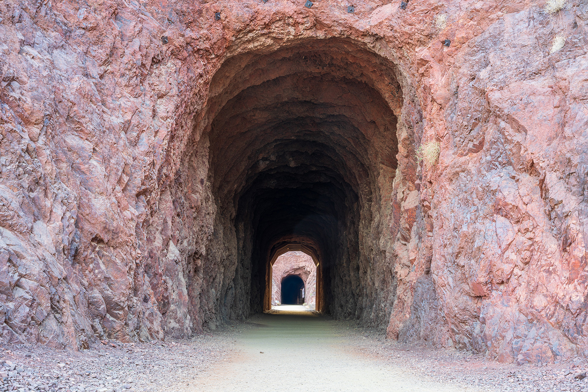 Landscape image showing two tunnels on the historic railroad trail