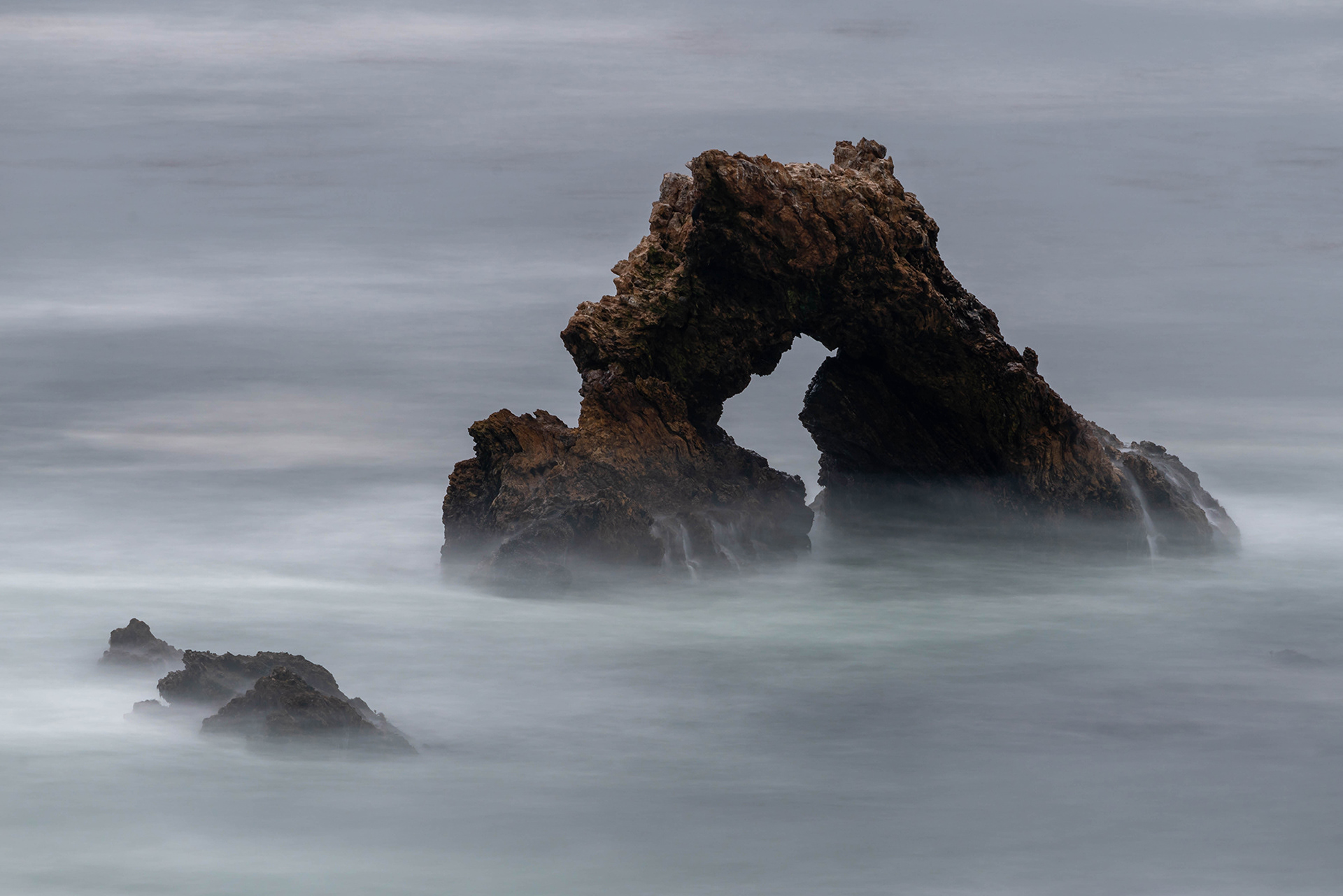 California seascape long exposure image of arch rock