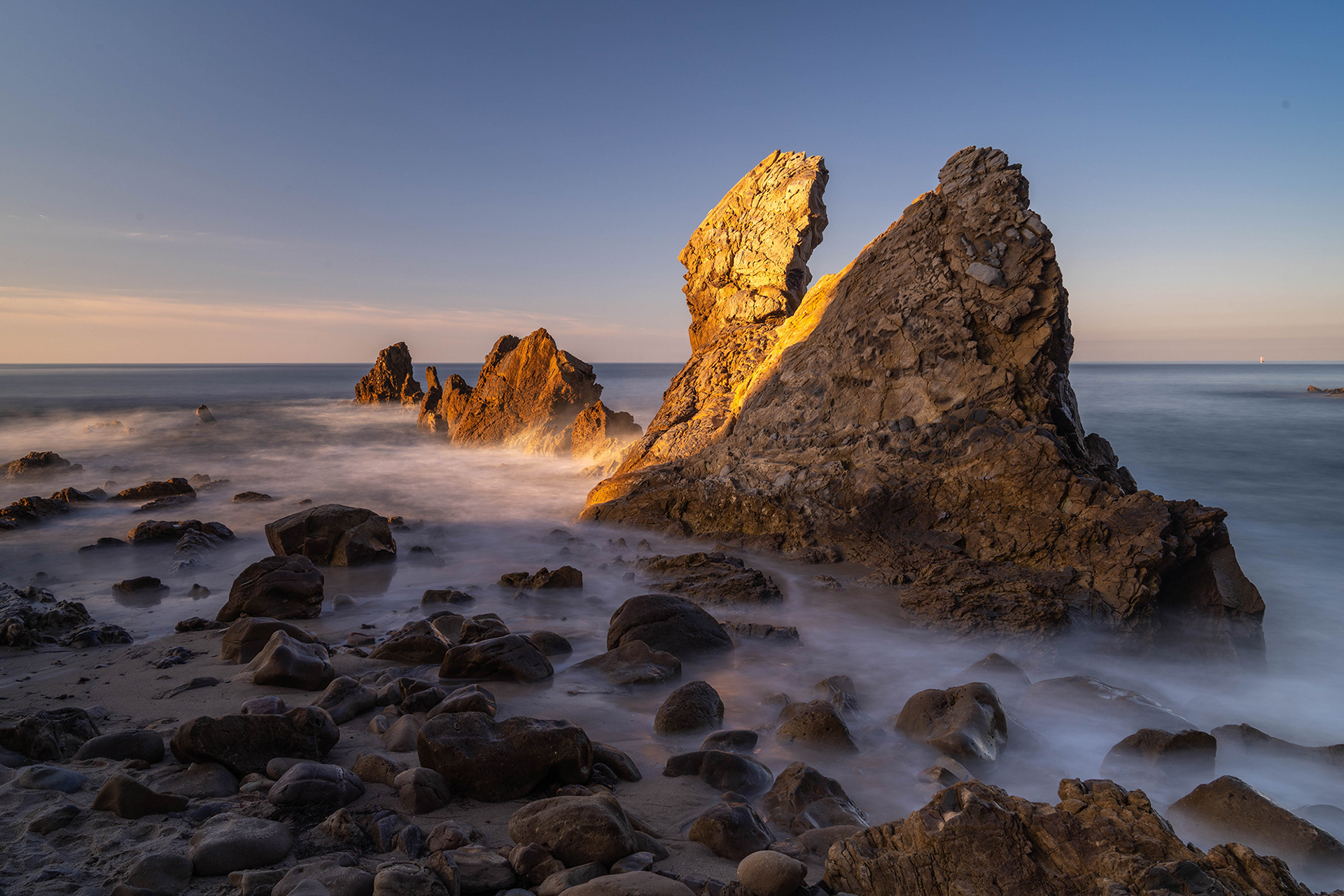 California seascape image of beach rocks in the morning sunshine