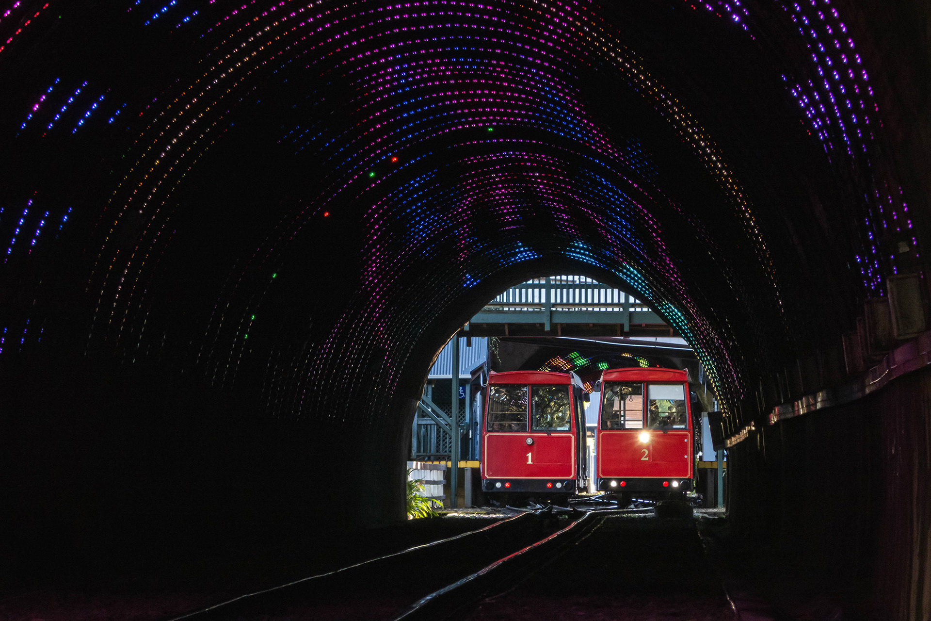 View of the cable cars passing at the half-way point taken from below through the tunnel 