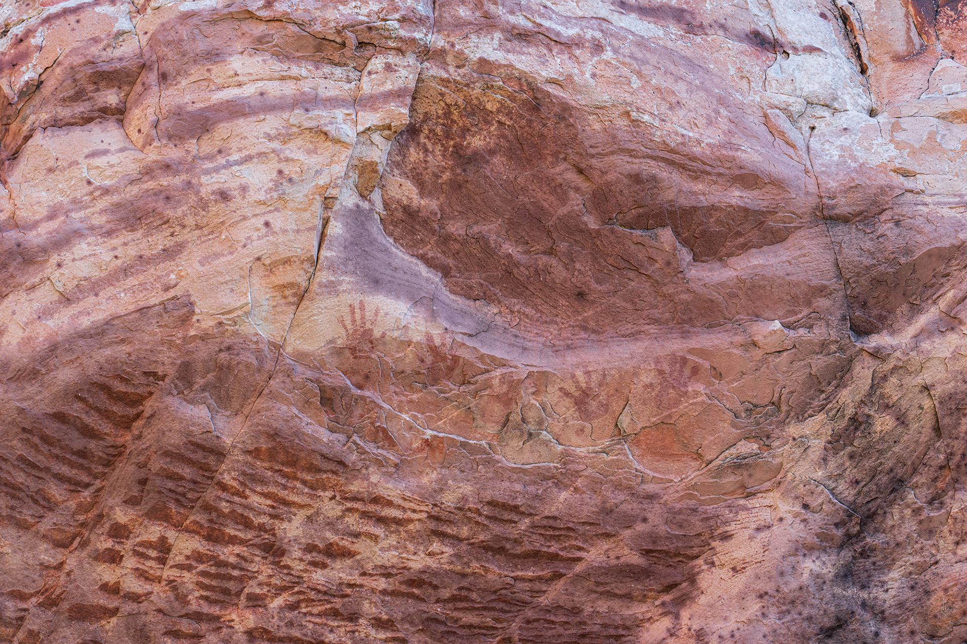 Pictographs painted onto the surface of the rock, or by printed by hands in this case