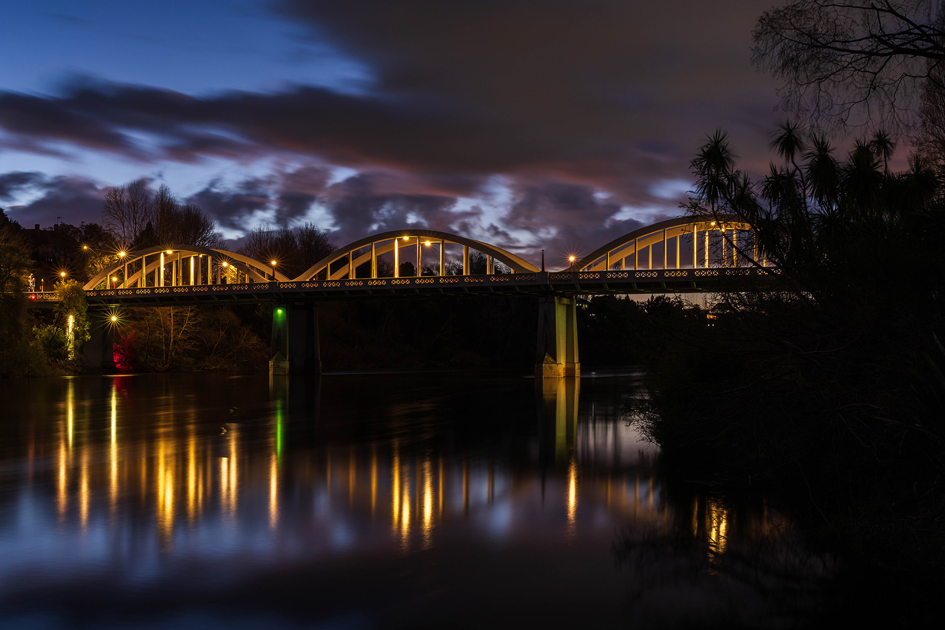 The Fairfield Bridge captured in the blue hour lit up with reflections in the Waikato River