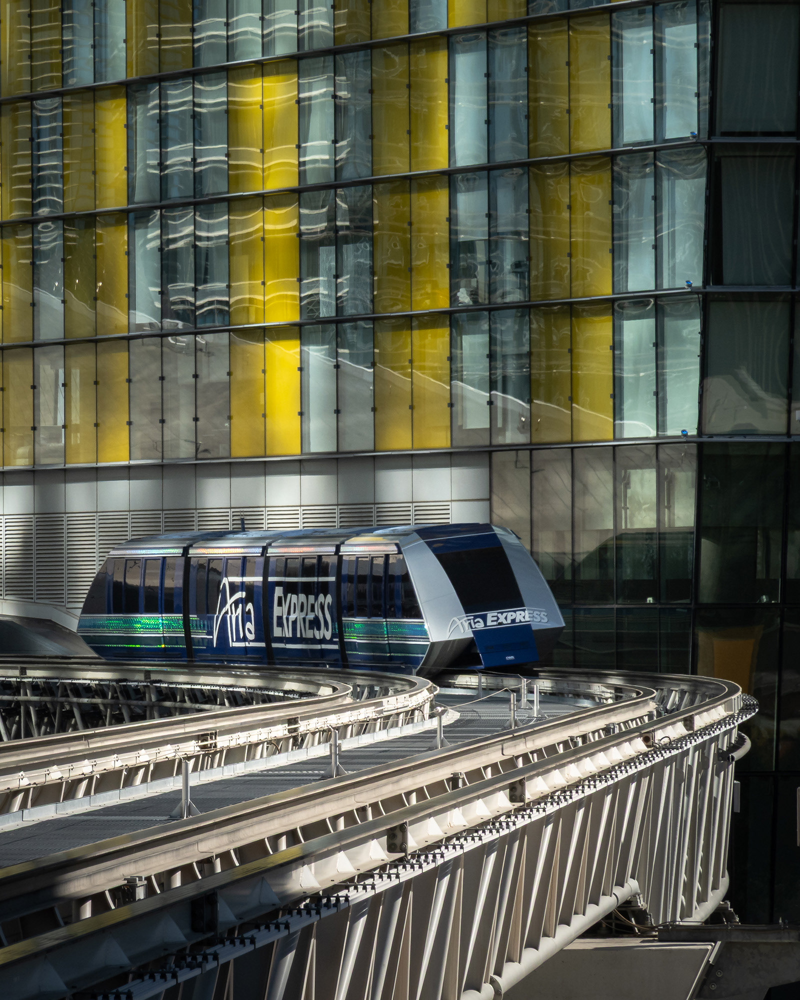 Aria Express tram in Las Vegas passing by one of the colourful Veer towers