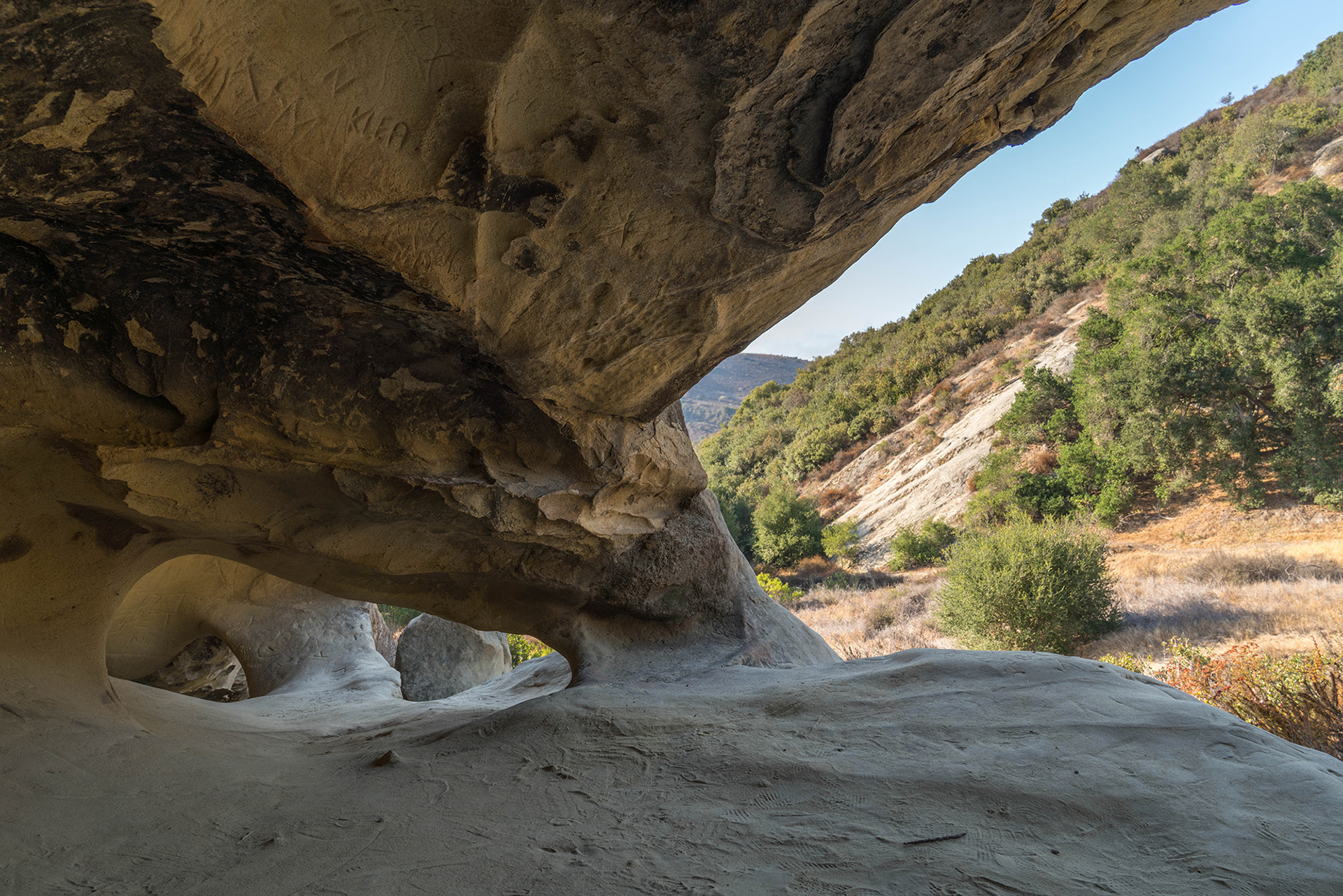 California landscape of caves with hills in the distance