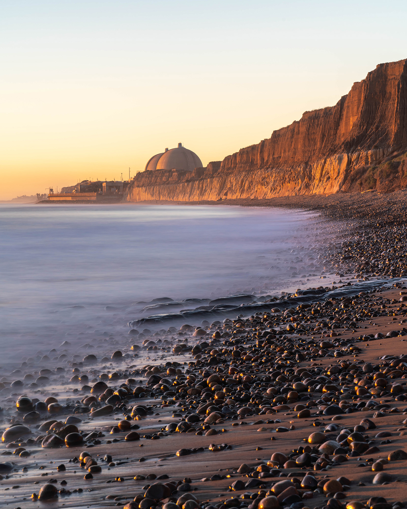California evening beach seascape image with distant power station