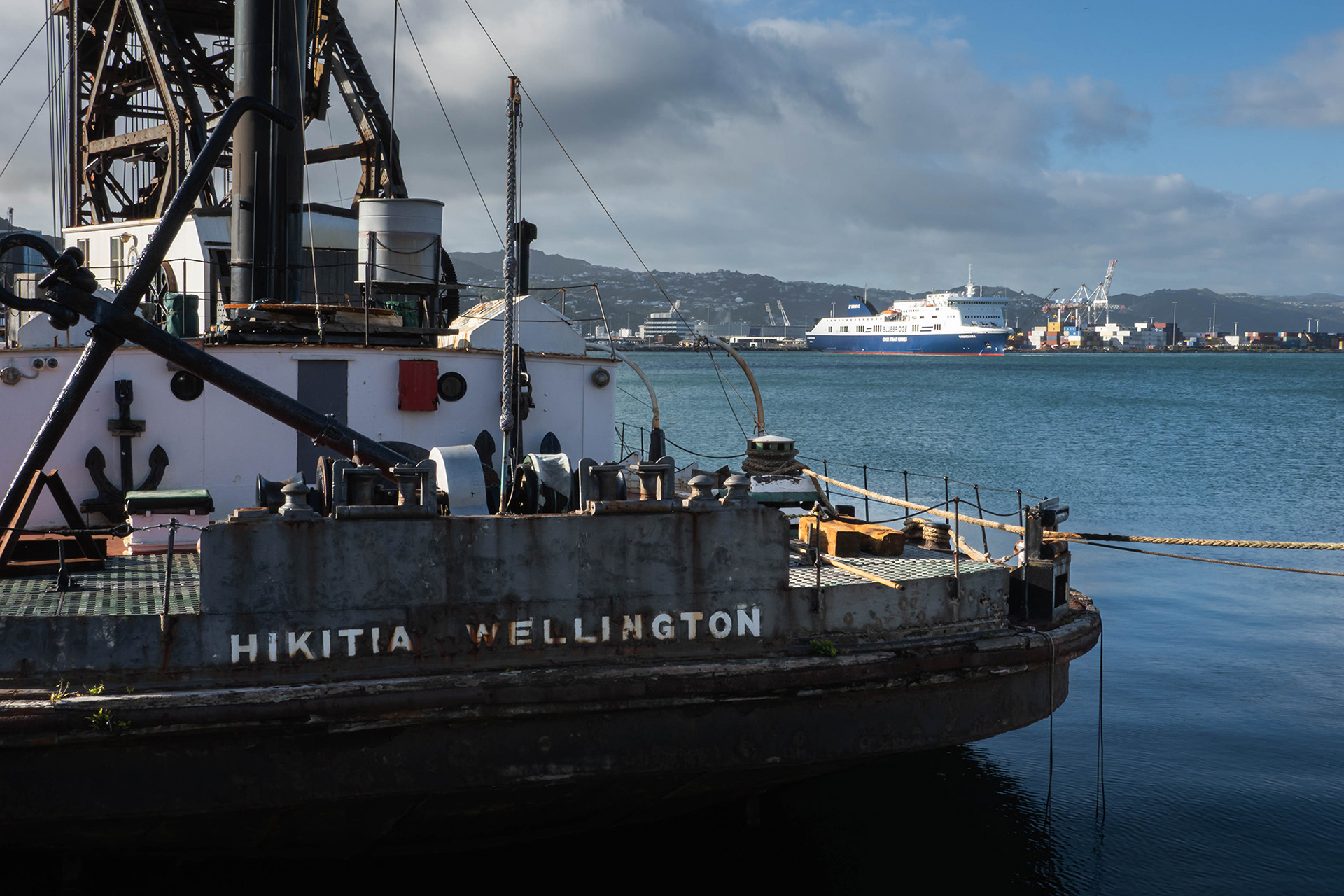 View of Wellington harbour showing the historic Hikitia floating steam crane in the foreground with the Cook Strait ferry in the background