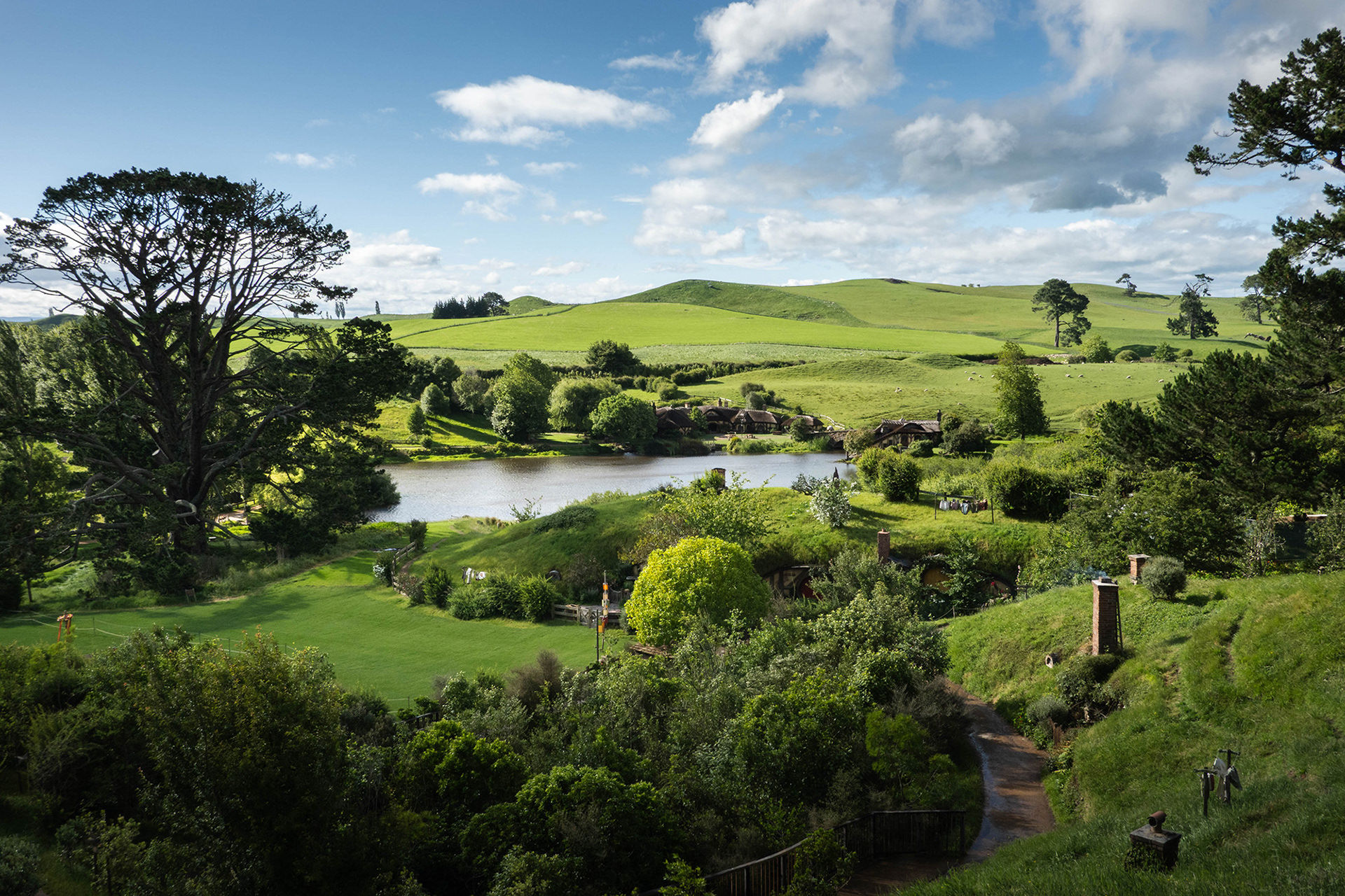 View from the hill looking down towards the Green Dragon Inn by the lake with the Party Tree and Party Field left foreground