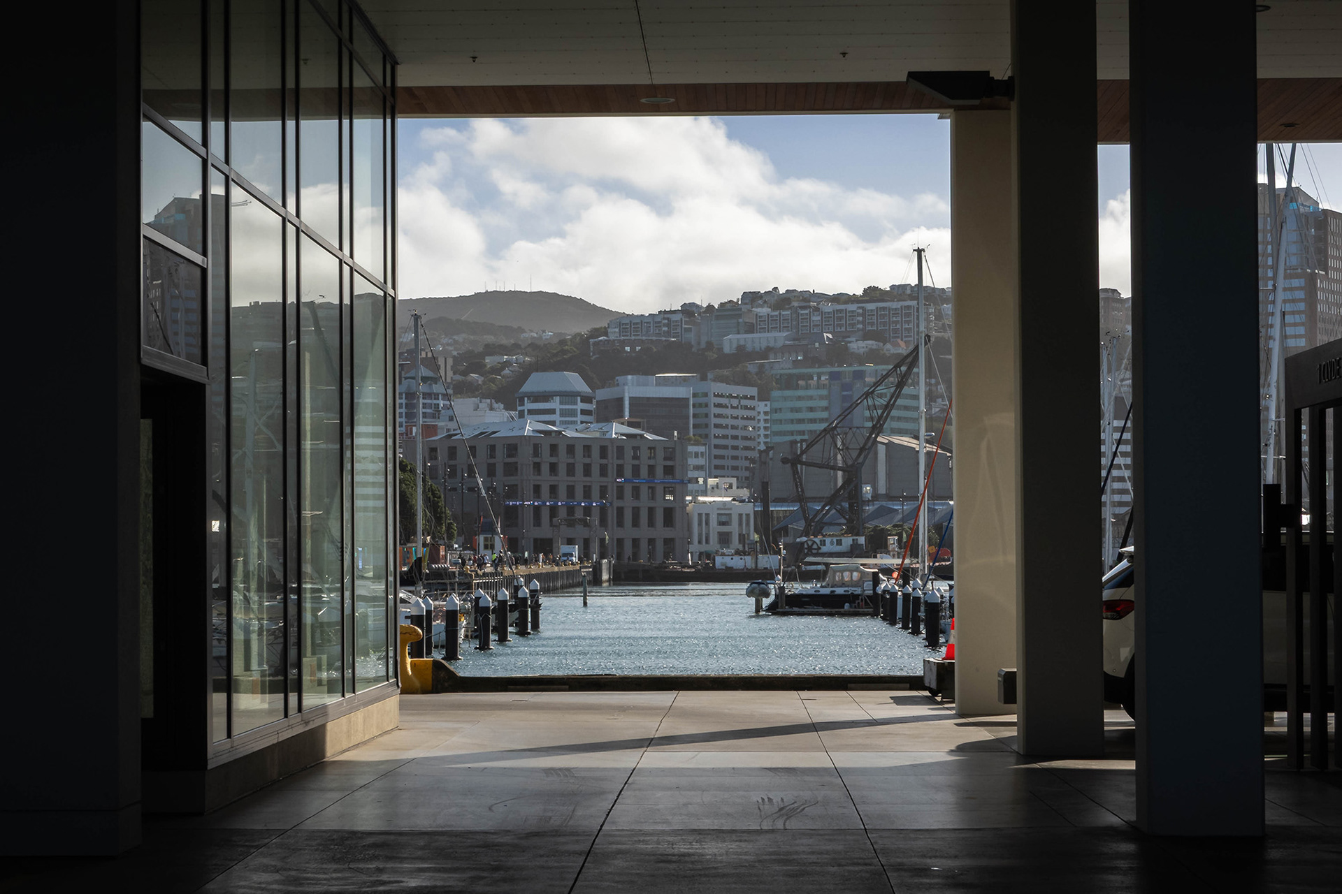 A view of the city and marina framed by the surrounding buildings of the Clyde Quay Wharf