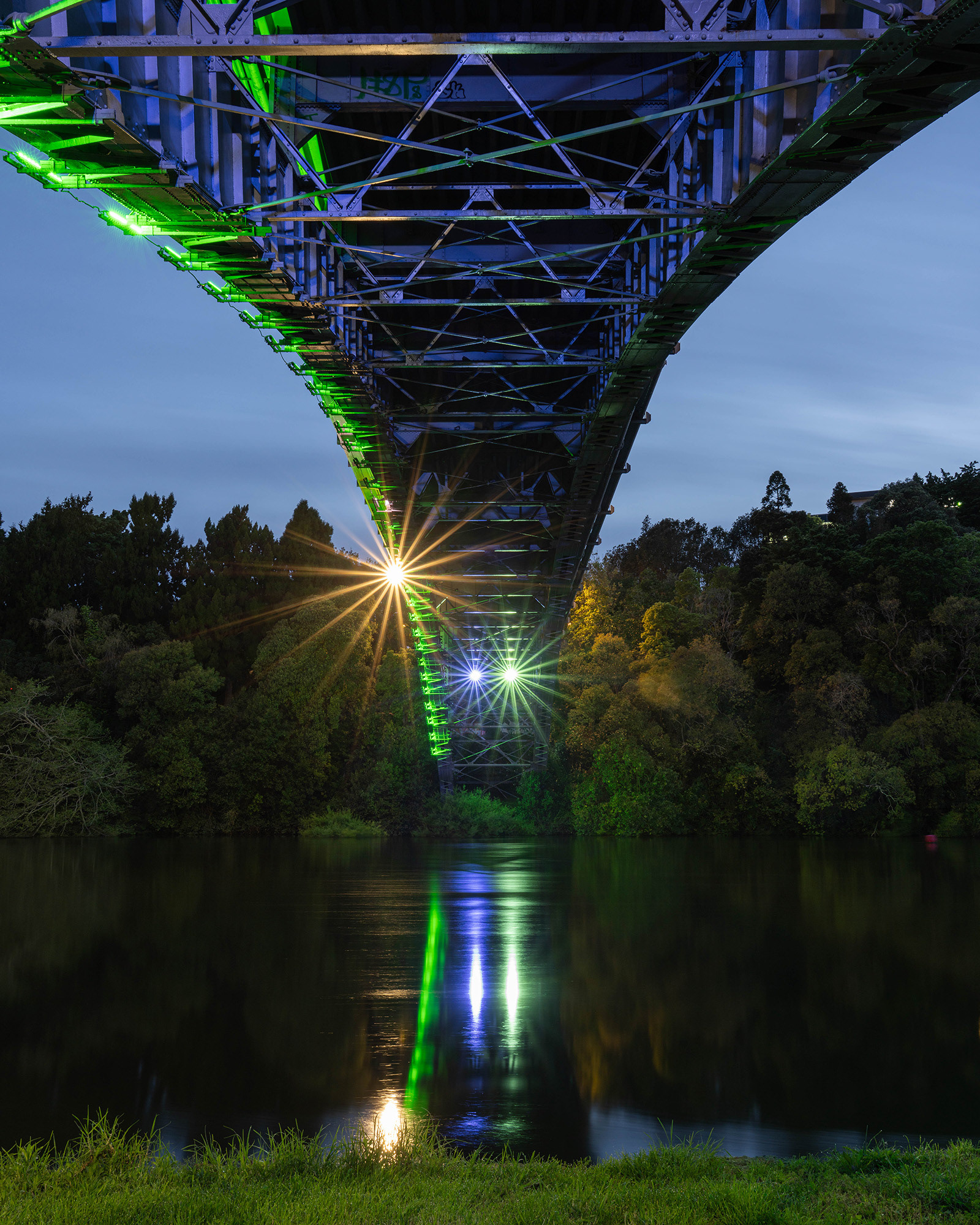 Underneath the floodlit Victoria Bridge captured in the blue hour 