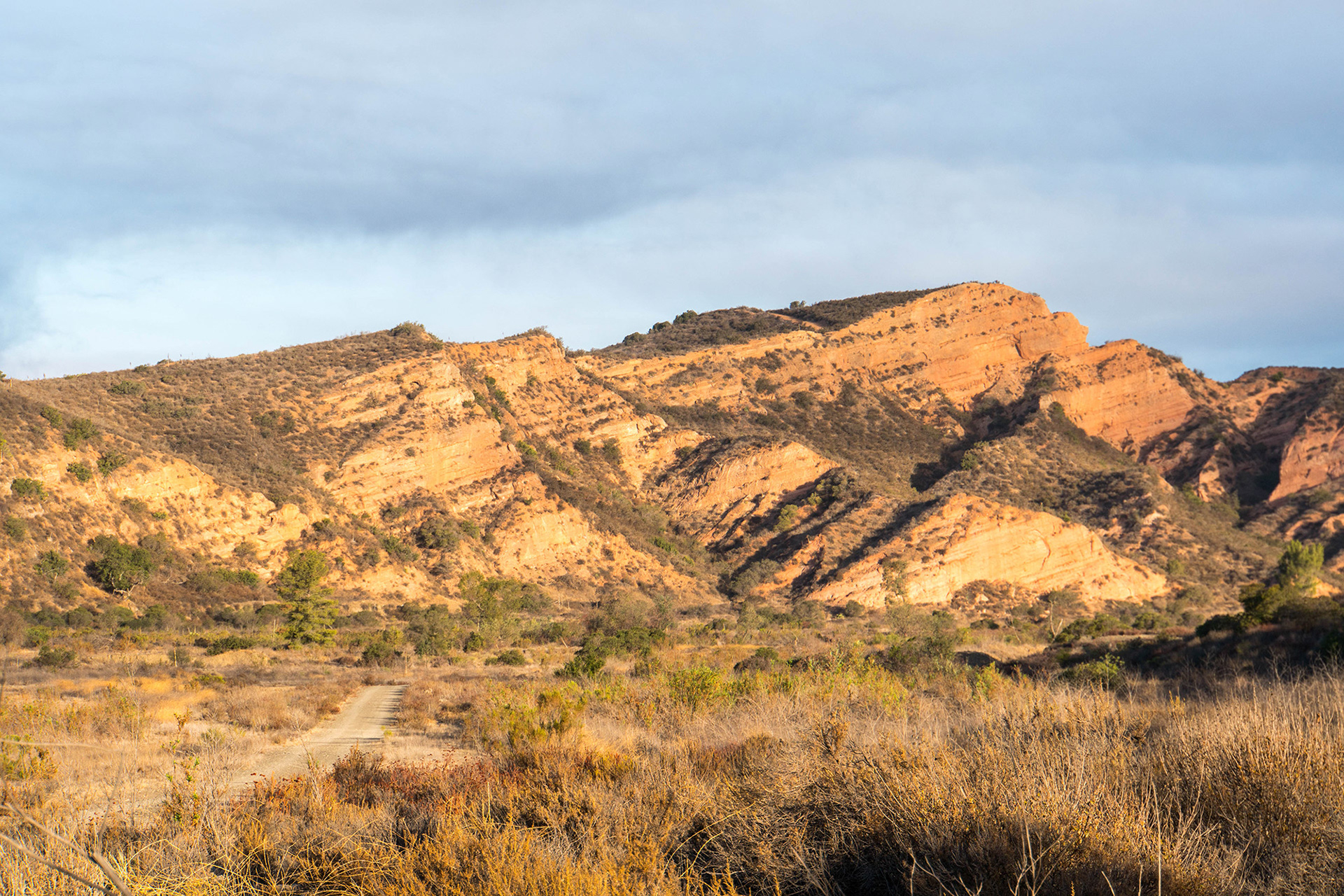 California landscape showing a distant red rock formation