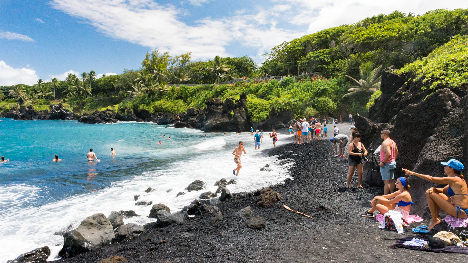 Black Sand Beach located on the Island of Maui within Waianapanapa State Park on the Eastern side of the island by Hana. The pitch black granules were created long ago by the rough surf pounding on a fresh, bubbling lava flow, courtesy of Haleakela. It took a millennia or more to be ground down into a beach. Today it is popular for swimming and sunbathing.