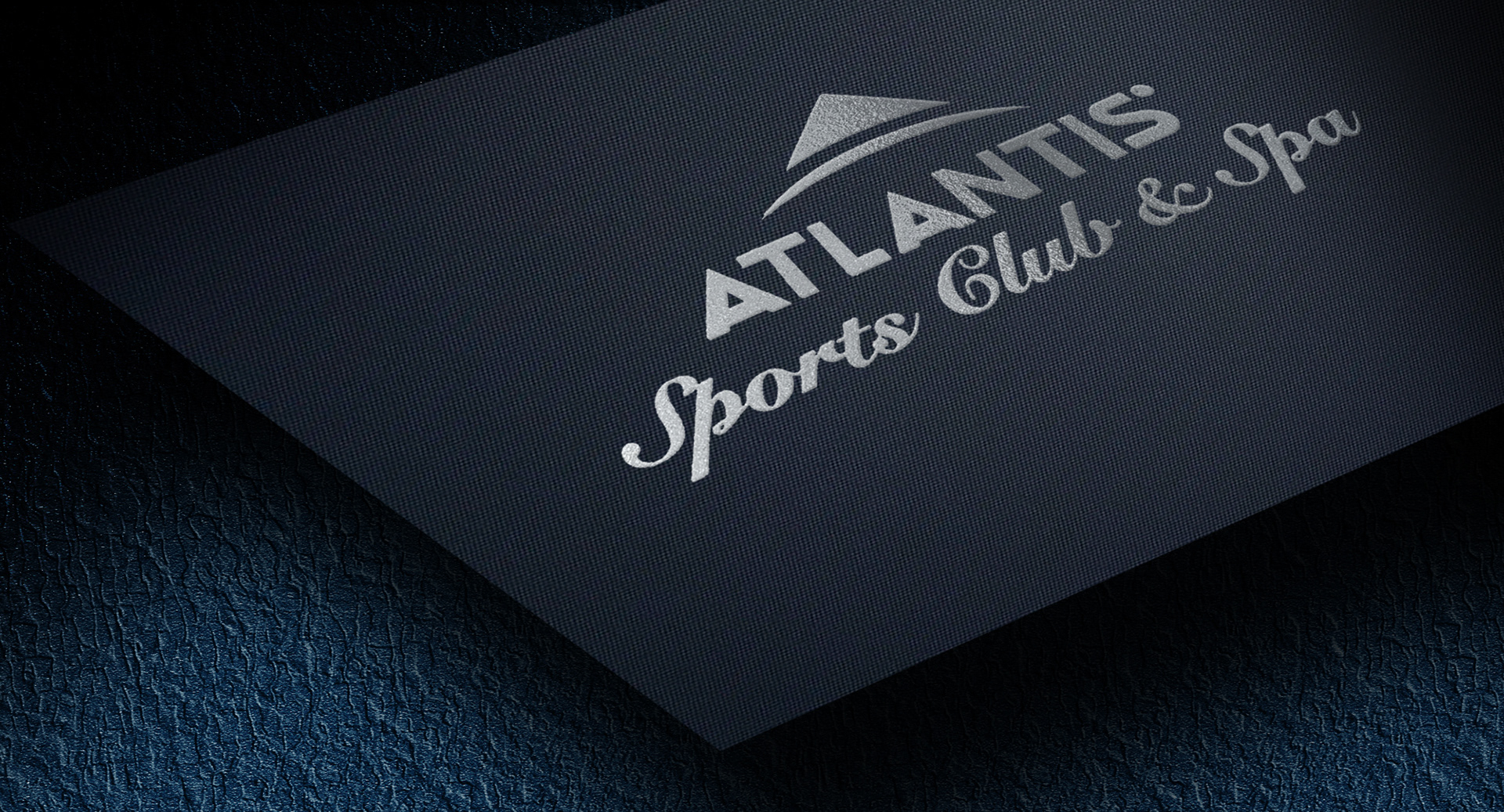 Close-up of metallic silver logo on premium navy stock, designed for wellness professionals seeking elevated branding.