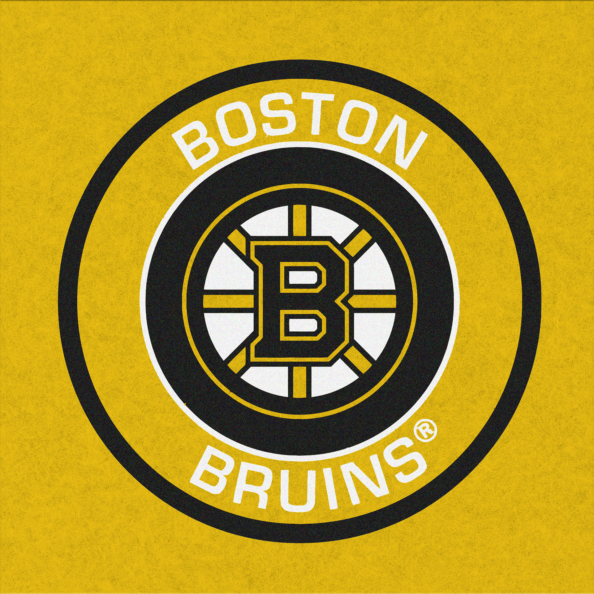 Boston Bruins logo test print in black and white on golden yellow pellon highlighting bold linework and color adaptability.