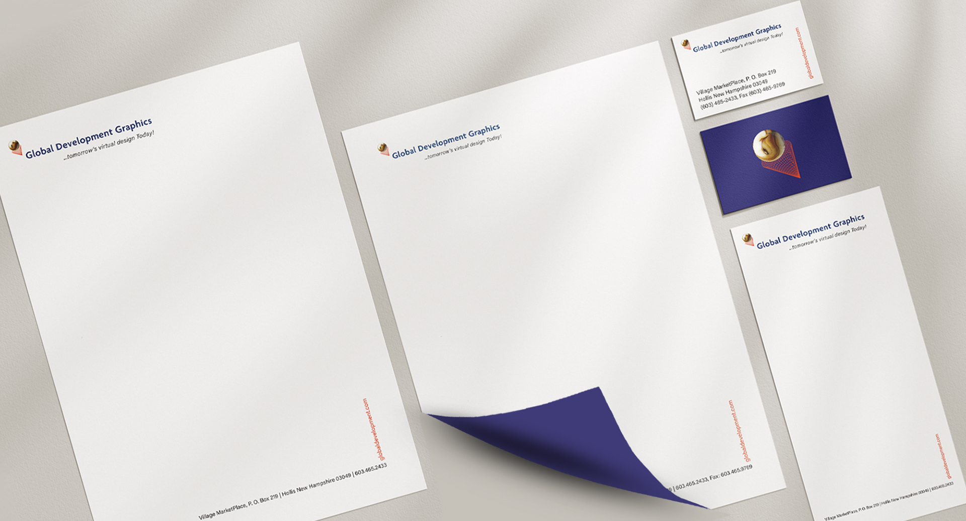 Flat-lay view of Global Development Graphics branded stationery set, including letterhead, business card, and envelope with the GDG globe icon.