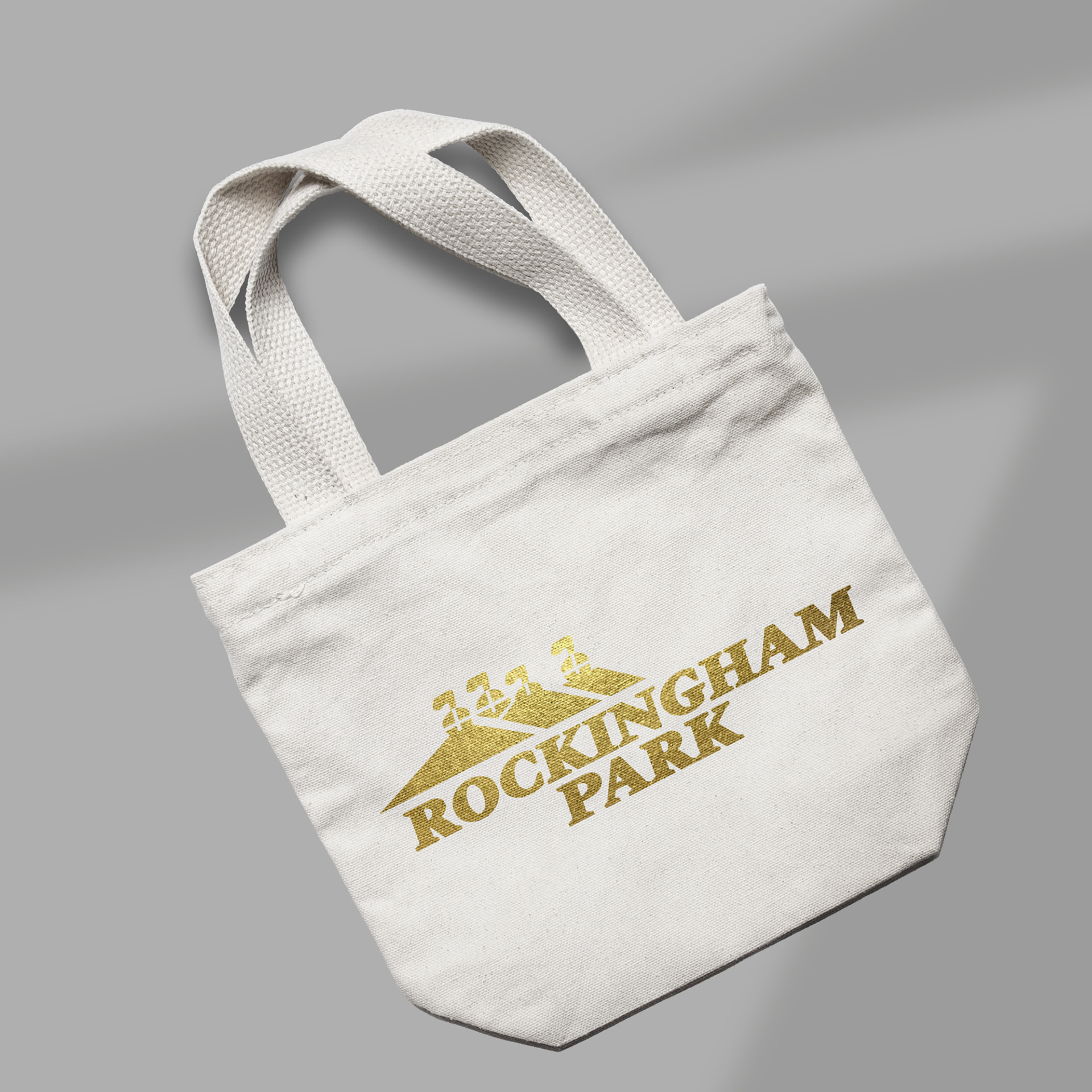 Bold metallic gold branding brought to life on canvas tote expertly designed and prepped for high-impact printing across merchandise.