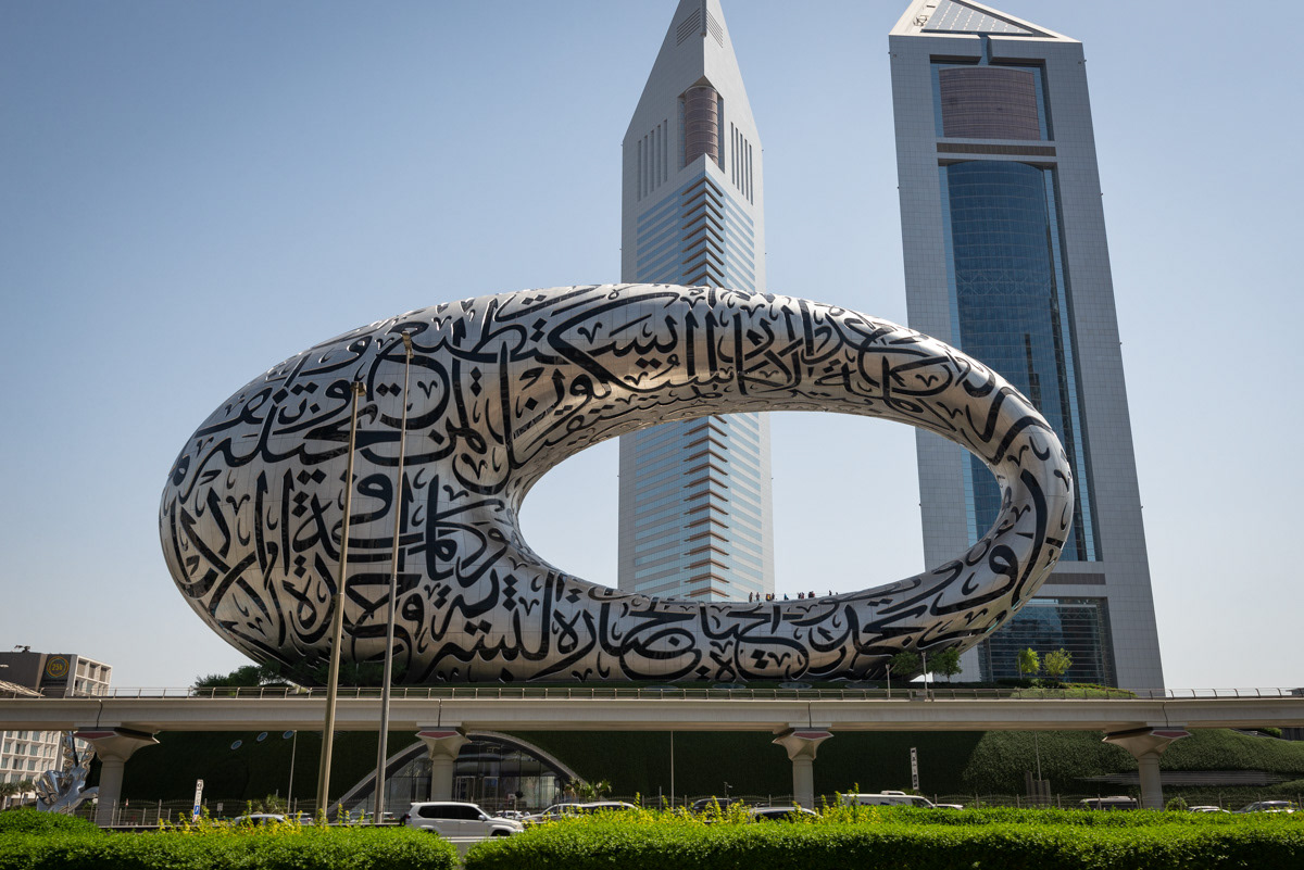 One of Dubai's most famous landmarks, the Museum of the Future was founded by the Dubai Future Foundation and opened in February 2022. Termed a 'living museum', the museum explores how society could evolve in the coming decades using science and technology, and combines traditional exhibits with immersive theatre and themed attractions, to help visitors envision the future's "limitless possibilities." Designed by architect Shaun Killa, the museum's shape is an asymmetric torus clad in steel and glass. The museum's striking exterior stands out thanks to its artistic use of Arabic calligraphy, which also function as glass windows. Designed by Emirati artist Mattar bin Lahej, the calligraphy reflects lines of inspirational poetry by HH Sheikh Mohammed bin Rashid Al Maktoum, Vice President and Prime Minister of the UAE and Ruler of Dubai. Of the three quotes enveloping the facade, one translates to: “The future belongs to those who can imagine it, design it and execute it. It isn't something you await, but rather create.”