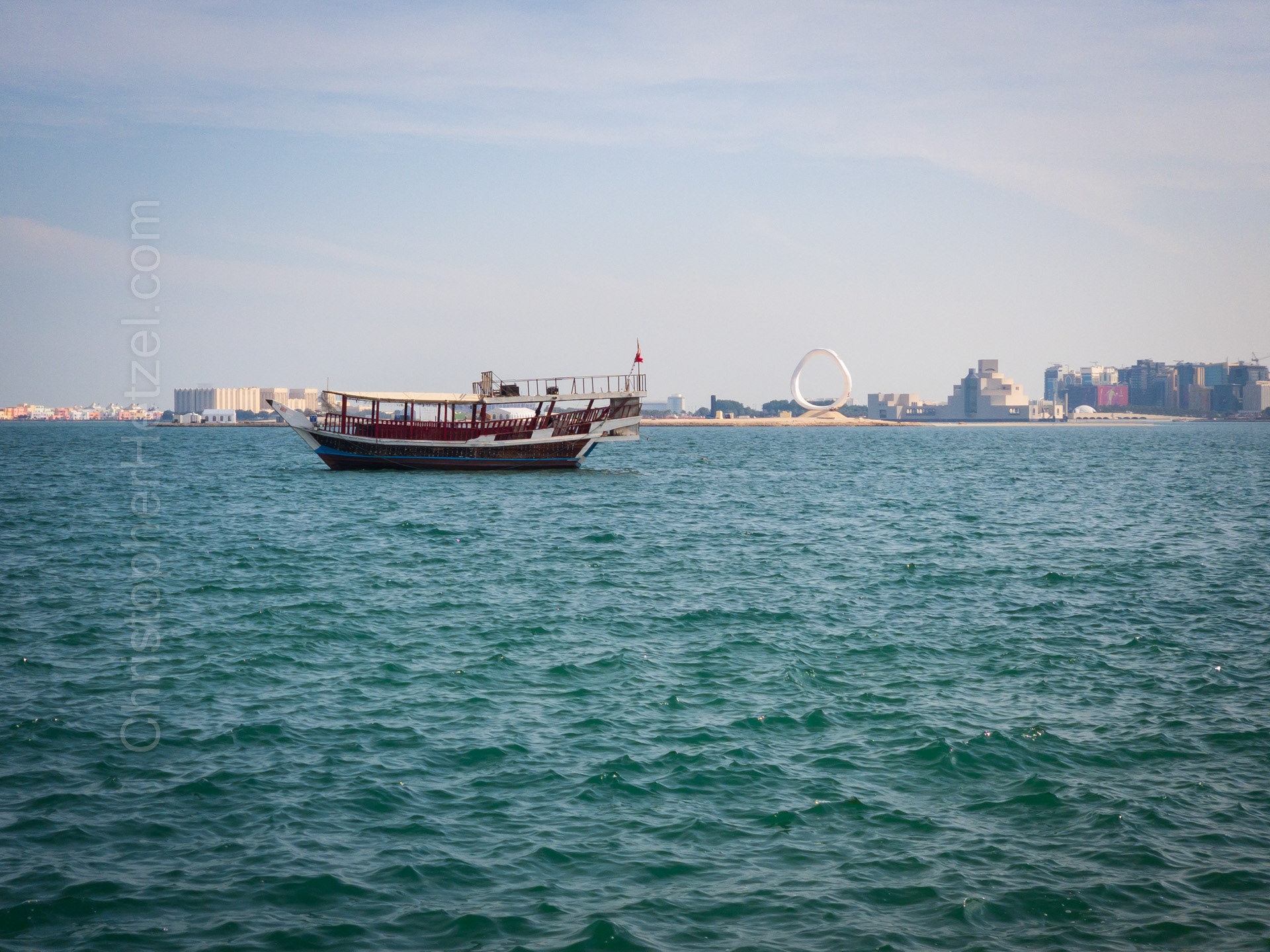 A view of Doha harbor, and the World Cup emblem in the distance.