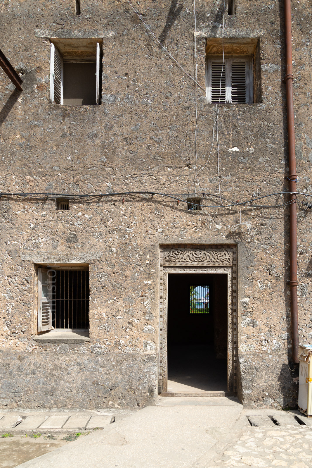 A traditional door, but you can also see the unfinished coral stone of its 18th century building.