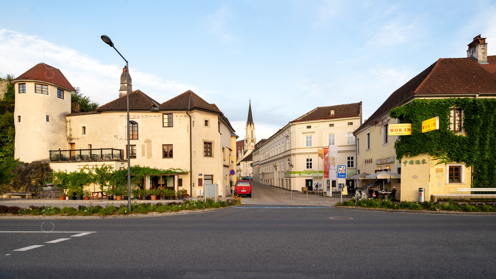 The building on the left contains a remnant of the town's medieval walls. There was once a prominent gate here, leading into the city from the river. The church in the distance stands on the town square. The river is behind me.