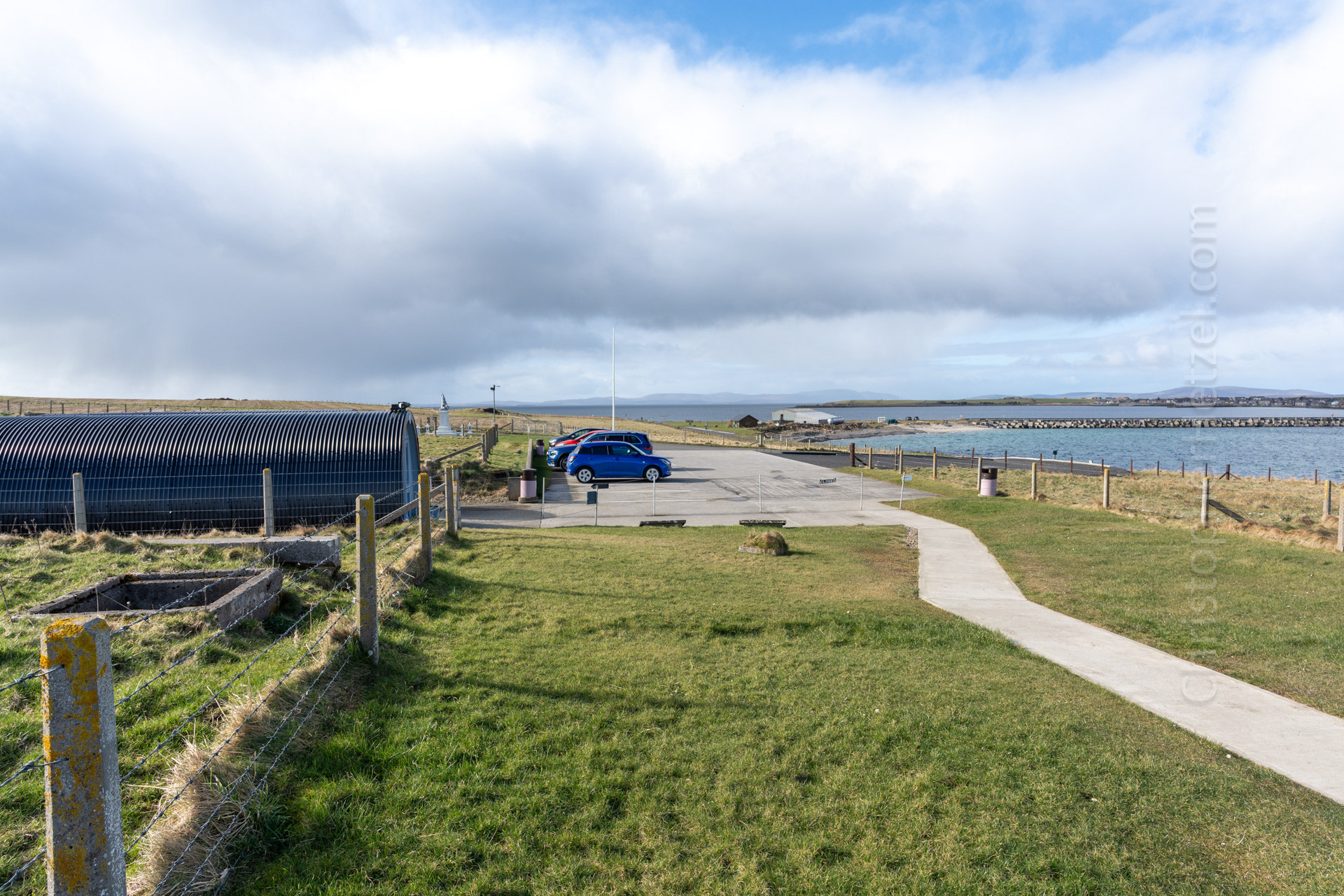 View from the chapel's front door. One of the Churchill Barrier's is visible in the water on the right.