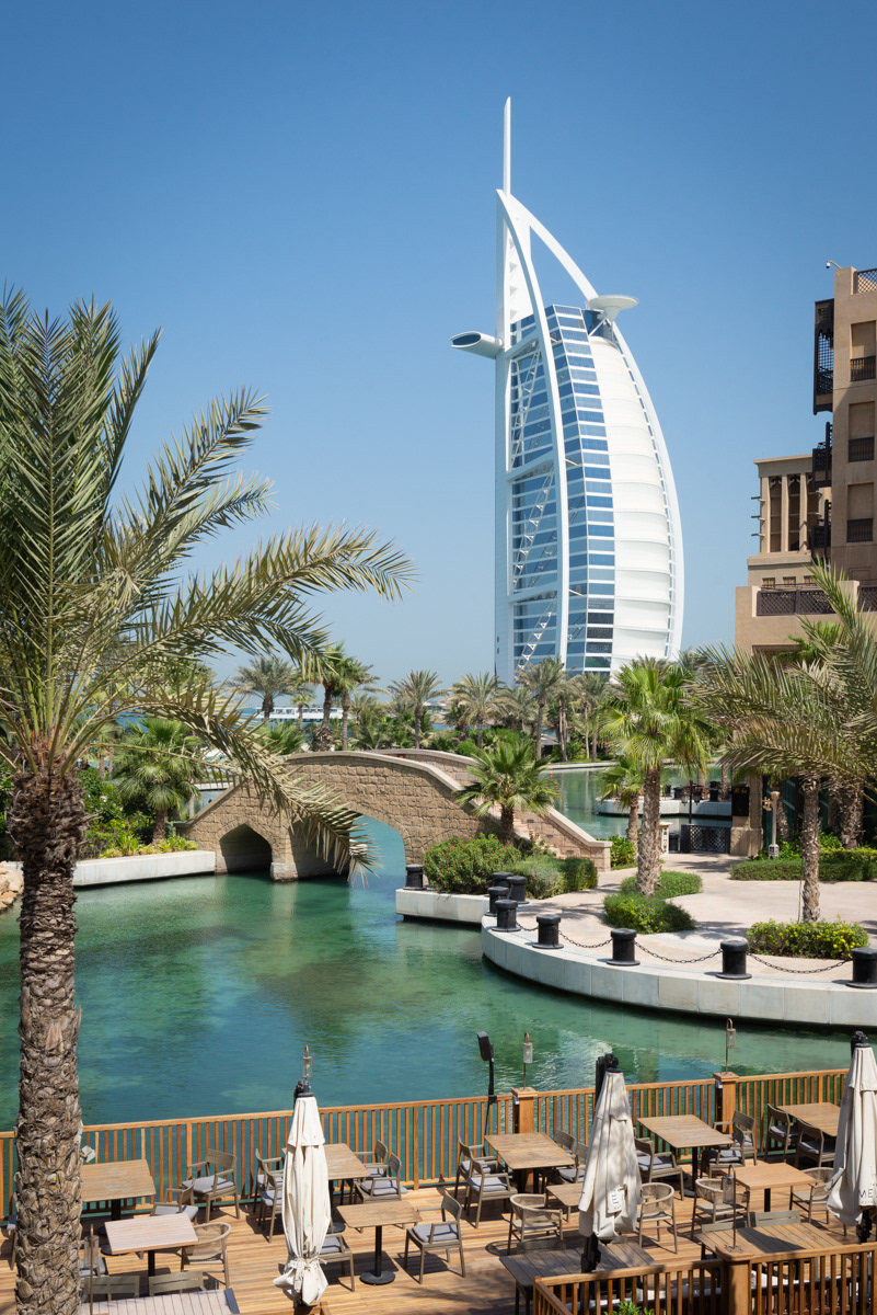 Burj Al Arab is a another of Dubai's luxury hotels. It was designed by the multidisciplinary consultancy Atkins, led by architect Tom Wright, and opened in 1999. It stands on an artificial island connected to the mainland by a curving bridge. The structure's shape is designed to resemble the sail of a ship.