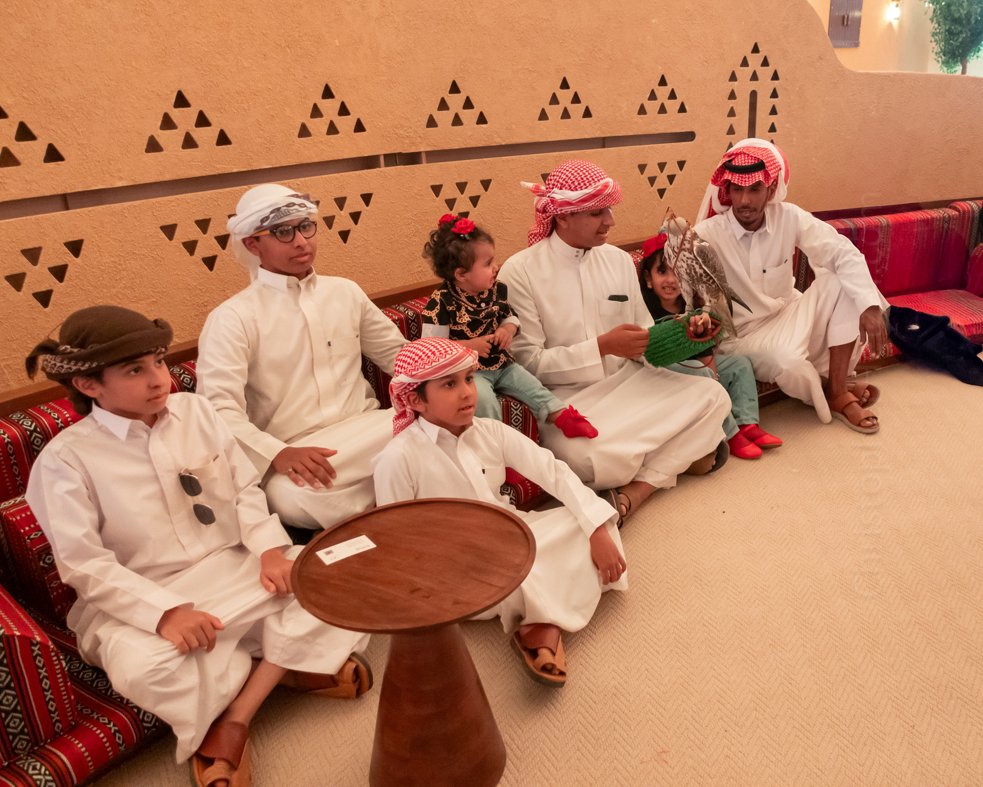 A Saudi family posing for photos with one of the falcons.