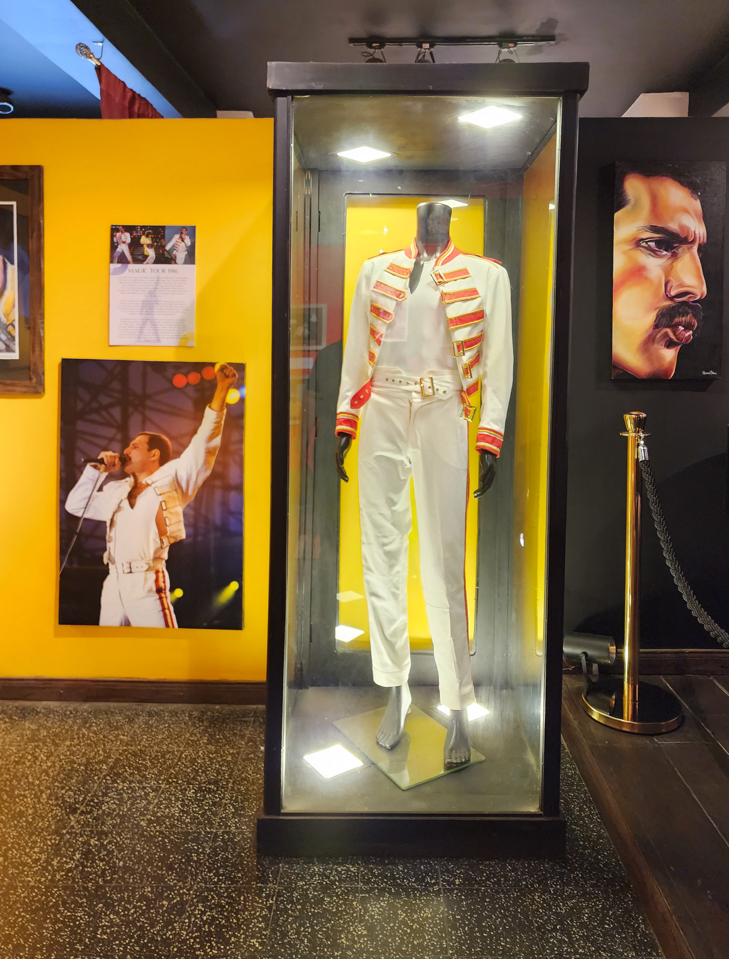 A red and white cotton twill military-inspired jacket worn by Freddie Mercury on Queen's 1986 Magic Tour. This was Queen's biggest tour and Mercury's last with the band. Photo by Jennifer.