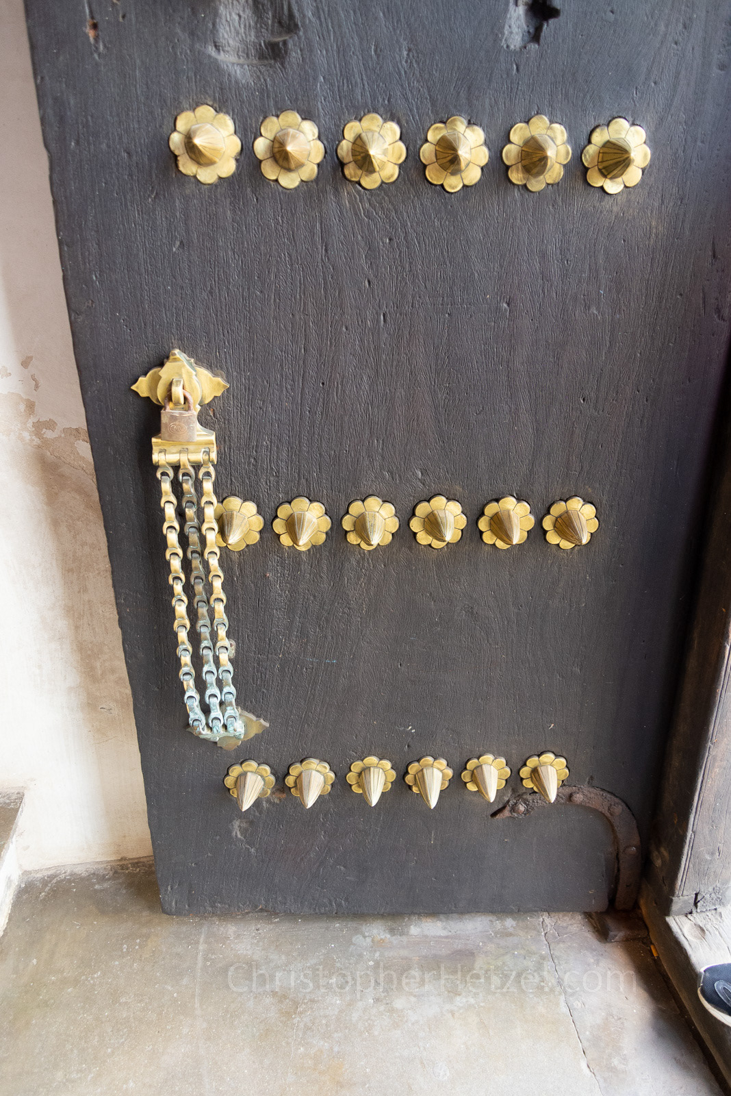 Front door to the Old Customs House, fitted with elephant-defying brass studs and chain lock.